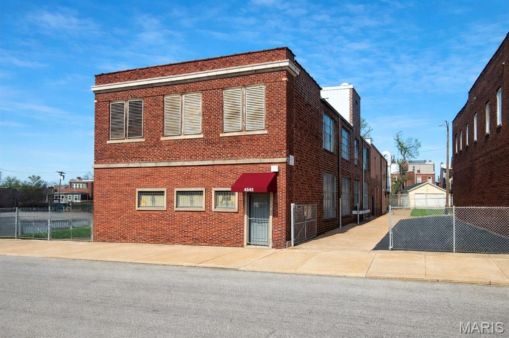 Rare industrial/warehouse opportunity with ample parking in St. Louis' Central Corridor. 10,920+/- SF two-story building on two parcels totaling 17,495+/- SF (4545 & 4549 Olive St.). Previously served as 7-Up bottling company headquarters and most recently a machinist shop for the last 50+ years. Features include 3 phase heavy duty electric, newer roof, large drive-in door (ability to add more), functioning freight elevator, rear alley access, etc. Includes small, finished office area at entrance with kitchen/breakroom. The partial lower level provides some additional storage and vintage bank vault. Property offers two fenced and gated parking lots on each side of the building (one is asphalt paved). Solid construction with flexible space suitable for warehouse, maker space, showroom, creative office, redevelopment, etc. Positioned just east of the Central West End and minutes from the Delmar Loop, surrounded by a strong mix of established retailers, restaurants, and destination businesses including Bowood Farms, Bowood by Niche, Shake Shack, Mission Taco Joint, and several local cafes, boutiques, and service users. Dense nearby population and consistent traffic from BJC/WashU Medical Campus and Cortex Innovation District. All equipment and contents currently in the building may be purchased or removed prior to closing. Original 7-Up stamped concrete detail still visible on-site.