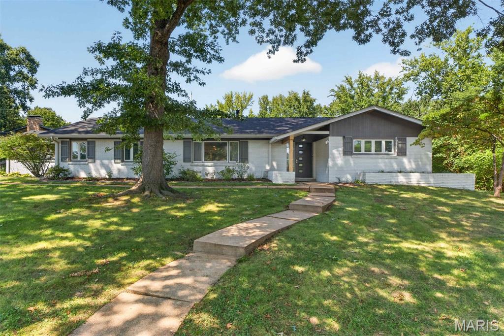 Welcome to this beautifully updated mid-century ranch, offering a perfect blend of style, comfort and versatility. A standout feature is the exceptional bonus suite, ideal for a private guest apartment, in-law suite or teen retreat. With its own private entrance, this flexible space includes  a bedroom, full bath, cozy living area and mini kitchen, providing endless possibilities to suit your lifestyle. The thoughtfully designed kitchen features granite countertops, custom cabinetry and opens to a welcoming Family Room with a charming stone fireplace and built-in bookcase. The spacious Living/Dining Room features a vaulted ceiling, creating an inviting, open atmosphere that is perfect for entertaining and everyday living. The generous Primary Suite offers three large closets and a private ensuite bath with double sinks and a spacious shower. Two additional bedrooms and two additional baths provide plenty of room. Step outside to your own private oasis, featuring an expansive patio and inviting pool area - perfect for summer gatherings, entertaining, or simply relaxing at home. Conveniently located in the highly desirable Ladue School District, this unique and versatile property is ready to welcome you home.
