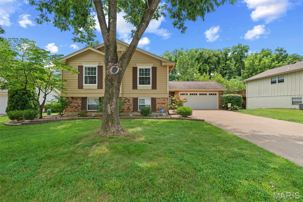 Nestled against a peaceful wooded green space, this well-maintained home offers the perfect blend of comfort, functionality, and outdoor living. The spacious living and dining areas open to a deck overlooking the private backyard, while the covered patio below creates another inviting space to relax or entertain. The fully fenced yard with multiple gates provides plenty of room for pets, play, gardening, or simply enjoying the outdoors.
The walk-out lower level expands your living space with a cozy wood-burning fireplace, making it the perfect family room, recreation area, or home office. Plumbing has already been installed for a future lower-level bathroom, offering additional potential for the next owner.
Pride of ownership is evident throughout with important improvements already completed, including a new HVAC system (2023), new garage doors and openers (2023), and sewer lateral replacement (2025), giving buyers peace of mind where it matters most.
Conveniently located just minutes from I-70, Mid Rivers Mall Drive, shopping, dining, parks, and everyday conveniences, this home offers a wonderful opportunity to make it your own while enjoying a fantastic location and a backyard setting that's hard to find.