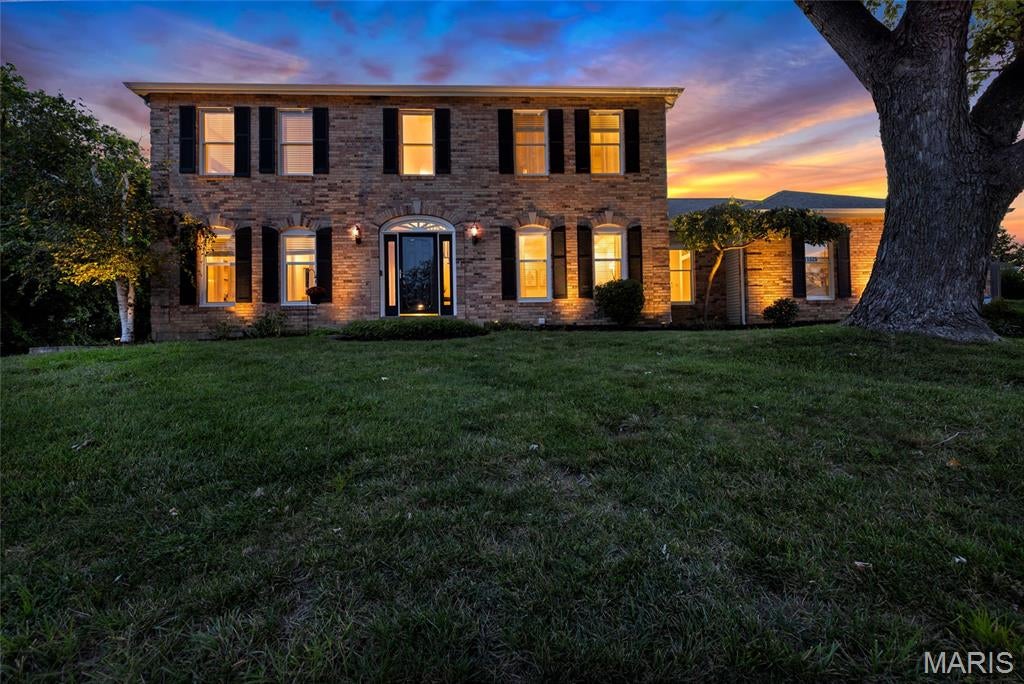Welcome to 15525 Windsor Ridge Court. Tucked away on a quiet culdesac in sought after Sycamore Place, this beautifully updated 4 bedroom, 3.5 bath two-story offers over 4,300 square feet of refined living on a picturesque .33 acre lot. Impressive curb appeal and fresh landscaping welcome you into the dramatic two story foyer, where a statement chandelier and rich hardwood flooring set an elevated tone. The entry is flanked by an elegant dining room with sculptured tray ceiling and modern lighting, and a spacious formal living room. The inviting family room showcases a stone surround gas fireplace, custom built-ins, bay window and wet bar, creating an ideal setting for relaxed entertaining. The refreshed eat-in kitchen features professionally painted cabinetry, stone countertops, stainless steel appliances, double wall ovens, center island, generous pantry and adjoining breakfast room with backyard access. A main floor laundry with utility sink and built-in cabinetry adds convenience. Upstairs, hardwood flooring continues into the serene primary suite featuring a coffered ceiling, double door entry, walk-in closet with custom organizers and spa inspired bath with dual vanities, jetted soaking tub and separate shower. Three additional bedrooms and a full hall bath complete the upper level. The finished walkout lower level offers exceptional versatility with a recreation area and wet bar, spacious family room with custom built-ins, tray ceiling and French doors to the backyard, plus a bonus sleeping area and full bath. Outdoors, enjoy a fenced yard, expansive stamped concrete patio and professionally landscaped grounds. Additional highlights include an oversized 3 car side entry garage, upgraded lighting throughout and newer roof, gutters and downspouts (2022). Ideally located within the award-winning Rockwood School District, this sophisticated, move in ready Chesterfield residence beautifully blends timeless design with modern updates.