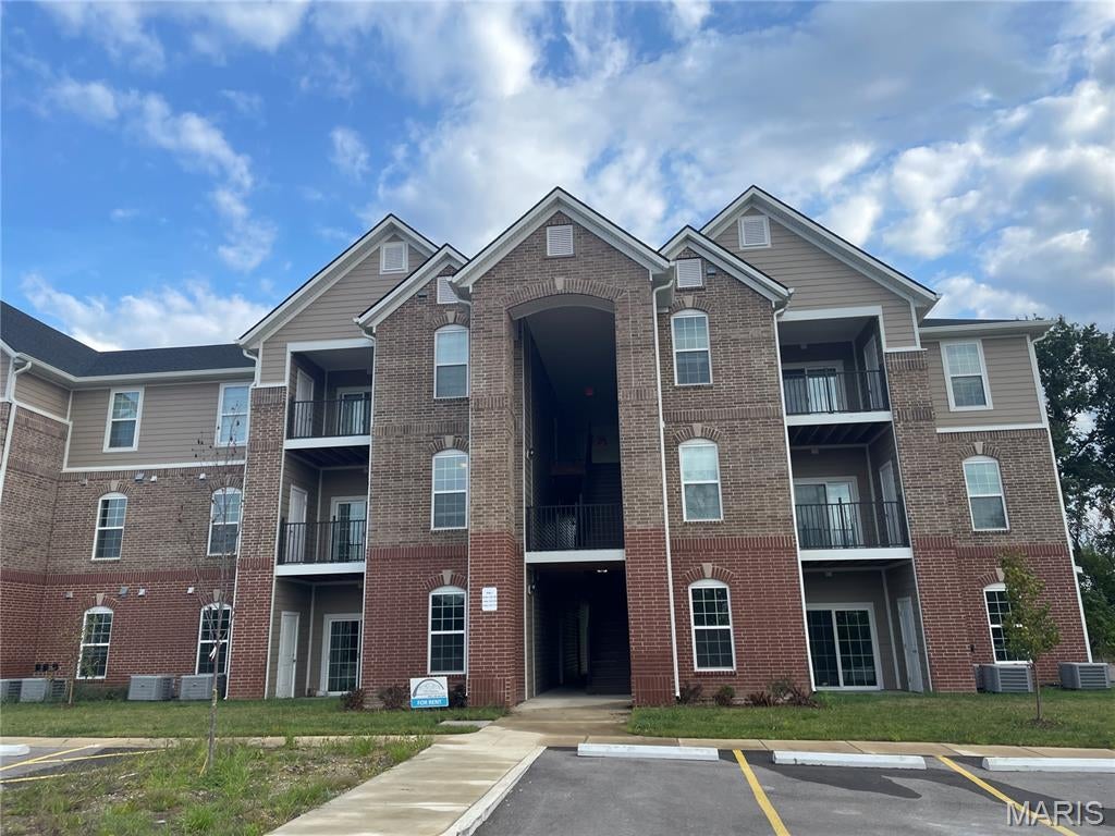 Investor Opportunity:  Tenant occupied.  Low maintenance property, built in 2025 built, 2 bedroom, 2 bathroom condominium is located in the rapidly growing Dardenne Prairie location and sought after Wentzville school district.   As you walk in you will be greeted with a naturally sunlit open floor plan with luxury flooring throughout. The cozy great room features 9 ft soaring ceilings, canned lighting, double paned doors, contemporary fixtures, an electric fireplace and is accessible to the covered composite balcony perfect for relaxing and offers privacy and beautiful views of trees and extra storage space. The spacious kitchen includes a deep sink and high faucet, 38" soft close custom cabinets with an amazing cooking ventilation built in, beautiful granite countertops, and complete with Whirlpool stainless steel electric range, dishwasher and refrigerator. The separate dining area is perfect for entertaining and has a pantry for additional storage. The master bedroom suite comes complete with a ceiling fan, an full bathroom with adult height vanity and a walk-in closet. Washer and dryer are included for convenience. Fantastic location, jump on the Page extension, near the Hwy 40 interchange, minutes away from Lakeside Shoppes At Winghaven, Chesterfield and Wentzville. HOA ALLOWS RENTALS!