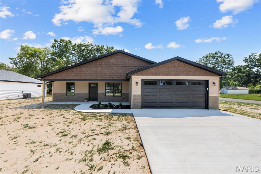 This charming 1,587 sq ft ranch, built by a trusted local builder, perfectly combines style and practicality. With a split bedroom layout, it features 3 bedrooms and 2 bathrooms, all set on a desirable corner lot. The kitchen impresses with white cabinets, granite countertops, and stainless steel appliances, flowing seamlessly into the open dining and living spaces. Cathedral ceilings enhance the airy feel, while earth-toned luxury vinyl plank flooring runs throughout. The primary suite is a peaceful retreat with a spacious bathroom and large walk-in closet. Two additional bedrooms are well-sized and share a nearby hall bath with a tub-shower combo. The laundry room is conveniently placed by the garage entry, and the garage itself is insulated, drywalled, and painted. With quality craftsmanship and thoughtful design, this Mary St. home is a must-see.