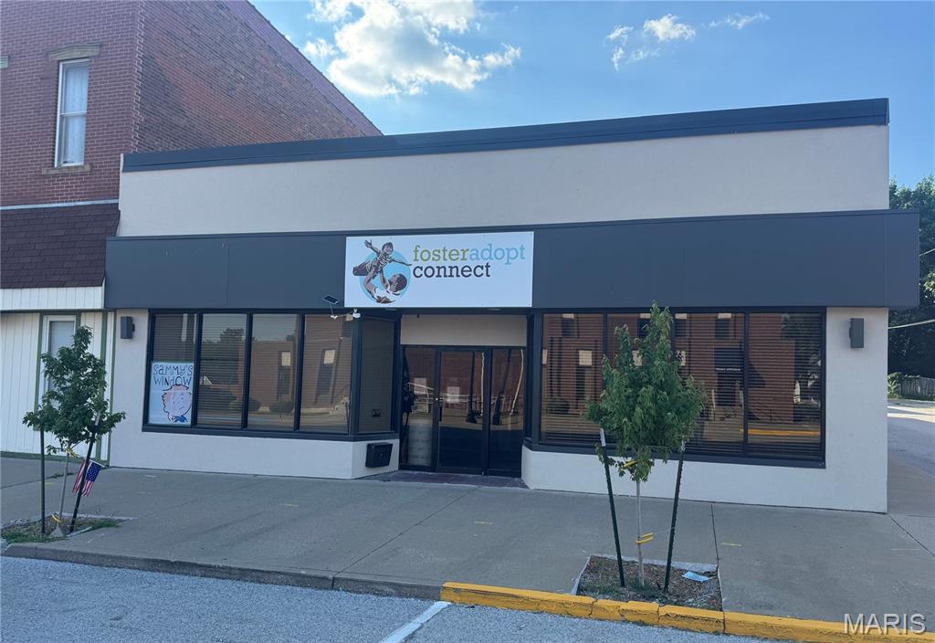 Excellent opportunity to own a well-maintained commercial building offering approximately 3,880 square feet in a highly visible Broadway location. Situated on a corner lot, this property features attractive stucco and brick construction with convenient off-street parking in the rear. The building is thoughtfully divided into two separate office suites, making it ideal for an owner-occupant who wants to operate their business on one side while generating rental income from the other—or easily utilize the entire building for one business. A glass vestibule provides access to both suites through separate entrances. Suite 1 features a spacious open work area with a front reception/counter space and 2 private offices. Suite 2 includes a front room and 3 private offices. The rear of the building offers a shared kitchenette with cabinets and refrigerator, a half bath, and separate a conference room. An interior hallway connects both sides, allowing the shared spaces to be accessed from either suite.
Additional features include 2 storage rooms, one of which is a secure bank vault, plus a rear entrance providing easy access from the off-street parking. Major updates include a new roof in 2023 with transferable warranty, and the HVAC systems have been updated in recent years. Suite 1 has fresh paint and flooring. This flexible, move-in-ready property offers endless possibilities for professional offices, accounting, administrative, financial, or other commercial uses. Tenant in Suite 2 is scheduled to move in September.
