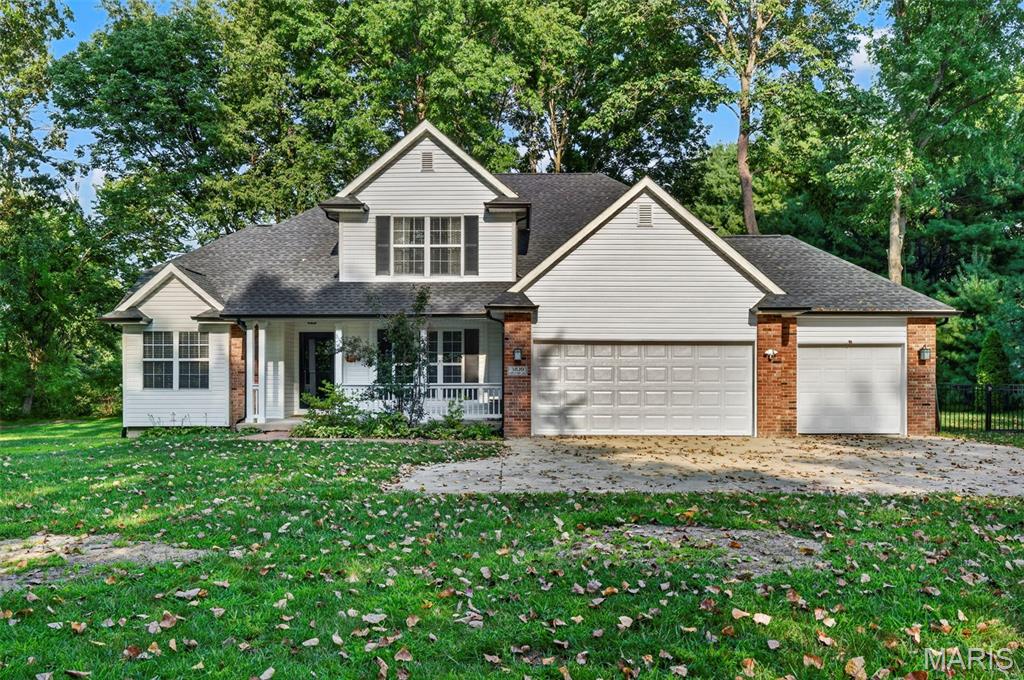 This picturesque home is tucked away on an ACRE surrounded by mature trees, creating your own private retreat! A long driveway leads you to the home, where you’ll find an oversized 3-car garage, tons of additional parking, plus a BRAND NEW roof, siding, and gutters! A cozy covered front porch welcomes you in and is the perfect spot for morning coffee or relaxing at the end of the day. Step inside to tons of natural light, brand new LVP flooring throughout, and impressive 12-foot ceilings. Just off the entry is a formal dining room that could easily serve as an office or flex space. The main-floor primary suite features a tray ceiling, spacious bathroom with a double vanity, tub, separate shower, and large walk-in closet. The open-concept living room is filled with windows and features a fireplace perfect for chilly winter nights, while the adjoining breakfast room flows into the kitchen with stainless steel appliances, plenty of countertop and cabinet space, and a pantry. A convenient half bath sits between the breakfast room and dining room, and to top it off, there’s main-floor laundry! Upstairs you’ll find three additional bedrooms and another full bathroom. The partially finished basement offers an abundance of additional living space, including a room that could serve as a family room or extra sleeping area, a huge recreation and living area, and a utility room with plenty of room for storage or a workshop. Out back, the fenced yard is lined with trees and bushes for added privacy, with plenty of space to entertain or unwind around the fire pit and covered gazebo. You’ll feel tucked away from it all while still being close to Downtown Edwardsville and just a short drive from both St. Louis and Scott Air Force Base! Additional updates include a new water heater in 2024 and one newer AC unit with zoned cooling. This home has everything you could desire, so schedule your showing today!