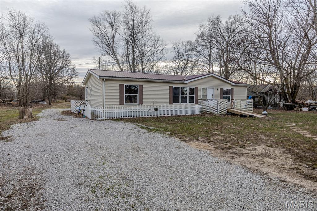 Located just north of Lebanon and minutes from Camdenton and Lake of the Ozarks, this 3 bedroom, 2 bath home sits on approximately 4.5 acres in a peaceful rural setting outside city limits. With a single-level layout, central heat and air, and a metal roof already in place, this property offers an affordable opportunity for buyers looking for space, privacy, and potential.

The land is open and usable, making it ideal for horses, a hobby farm, gardening, or anyone wanting room to spread out without breaking the budget. The long gravel drive creates separation from the road while still offering convenient access to both Lebanon and Camdenton.

Whether you’re a first-time buyer exploring government loan options, someone looking for an affordable place to make your own, or an investor searching for acreage with upside, this property checks a lot of boxes. Hard-to-find small acreage in this location and price range continues to draw attention, especially for buyers wanting country living with access to town and the lake area nearby.