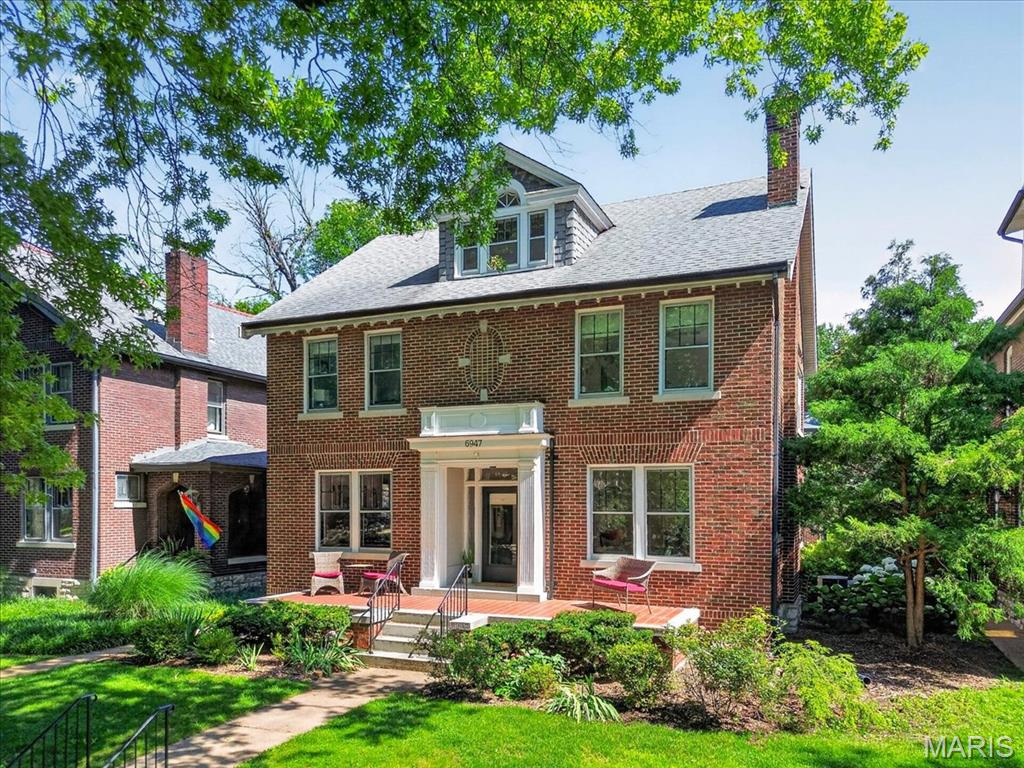 Stately and beautifully updated, this exceptional Ames Place residence blends timeless architectural charm with modern comfort. Offering over 3,200 square feet of living space across 2.5 stories, this classic brick home features soaring ceilings, rich hardwood floors, and outstanding curb appeal on a picturesque tree-lined street. 

A covered front entry and original glass front door create a warm and elegant first impression. The light-filled foyer is flanked by spacious formal living and dining rooms, ideal for entertaining. The living room showcases a gas fireplace and glass pocket doors, adding character and versatility. The updated kitchen is a chef’s delight, featuring marble countertops, a subway tile backsplash, wine refrigerator, breakfast room, and dedicated coffee nook. The kitchen flows seamlessly into the expansive family room, complete with built-in bookshelves, a comfortable TV area, and additional sitting/play space.

Upstairs, the serene primary suite offers a beautifully appointed ensuite bath. Two additional generously sized bedrooms and a large full bath with convenient second-floor laundry complete this level. The third floor provides exceptional flexibility as a guest suite, home office, recreation room, or private retreat, with a walk-in closet and full bath.

Outside, enjoy the level, fenced backyard featuring a spacious composite deck, garden areas, stone patio, and ample space for outdoor gatherings. A two-car brick garage plus an additional parking pad for a third vehicle provide rare convenience.

Ideally located within walking distance of Delmar Loop, Washington University, and Forest Park, and just a short bike ride from Clayton, this remarkable home offers the perfect combination of historic elegance, modern updates, and an unbeatable location.