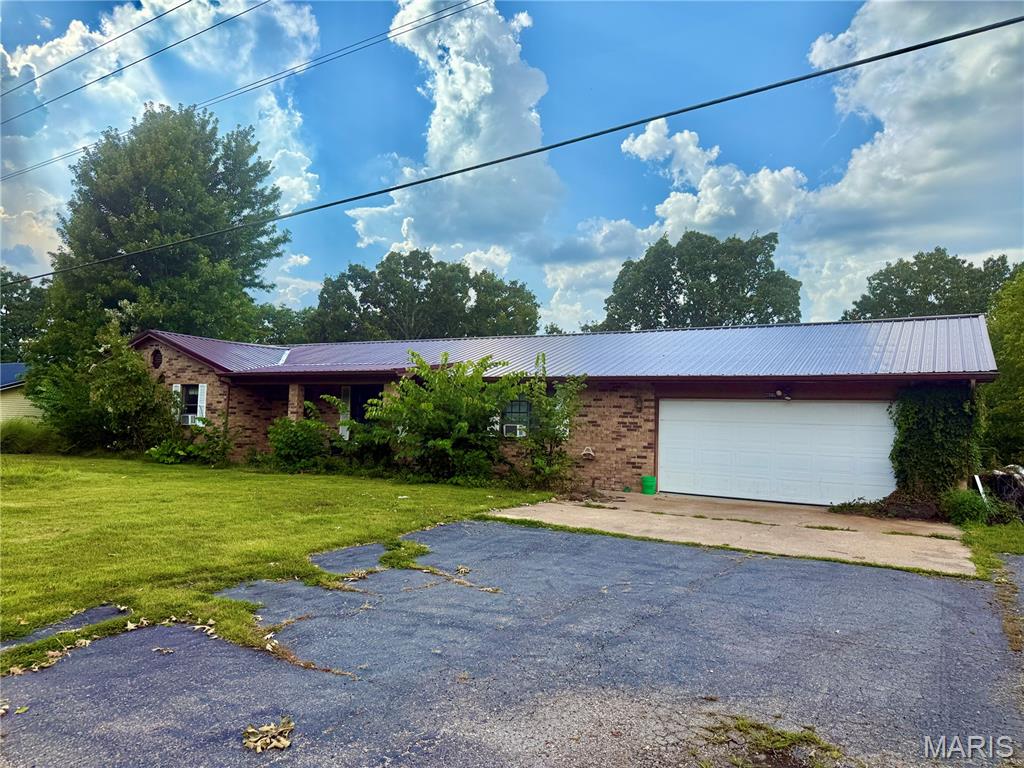 Discover the perfect blend of comfort, convenience, and potential with this charming ranch style home sitting on a FULL ACRE! Step inside to an OPEN FLOOR PLAN that creates a welcoming flow from the living room to the kitchen and dining area—ideal for everyday living and entertaining. Fire up the grill and enjoy evenings on your DECK while overlooking your front and back yard. The spacious 2-CAR GARAGE provides plenty of room for vehicles, storage, or hobbies, while the layout of this home offers flexibility to fit your lifestyle. Located just 10 MINUTES from WALMART in St. Robert and all the restaurants and amenities you could need, this property combines peaceful surroundings with convenient access to town. With its ample space, wooded charm, and thoughtful design, this home holds TREMENDOUS POTENTIAL for anyone looking to create their own vision. Don’t miss this opportunity to own a slice of comfort close to it all—schedule your showing today!