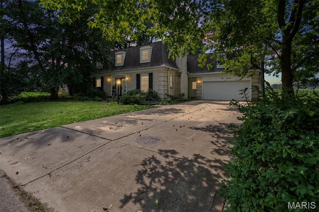 Welcome home to this beautifully maintained property situated on a desirable lot backing to a peaceful cornfield, this home offers privacy with a picturesque setting including mature trees. The inviting floor plan begins with a spacious foyer featuring a convenient drop zone and nearby half bath. Just beyond, you’ll find a cozy family room with a fireplace and custom built-in storage, while the formal living and dining rooms provide the perfect spaces for entertaining family and friends. The spacious kitchen is equipped with stainless steel appliances that stay, a pantry, breakfast bar, and a bright breakfast nook with patio doors leading to the deck—an ideal spot to relax and enjoy the tranquil backyard views. Upstairs, the primary suite offers a private bath with shower. Two additional bedrooms provide plenty of space, including one with an oversized bonus room that could easily serve as a large fourth bedroom, home office, playroom, or hobby room. Each upstairs bedroom features a charming window seat with built-in storage, adding both character and functionality. The hall bath includes a double-sink vanity and a tub/shower combination. The finished basement offers even more living space with a large family room, a full bath with a shower, and a laundry area where the washer and dryer remain. The unfinished storage area includes a professionally installed waterproofing system, providing additional storage and peace of mind.  Additional highlights include a two-car attached garage, abundant storage throughout, and an unbeatable location that combines neighborhood living with country views. This is a home you’ll be proud to call your own!