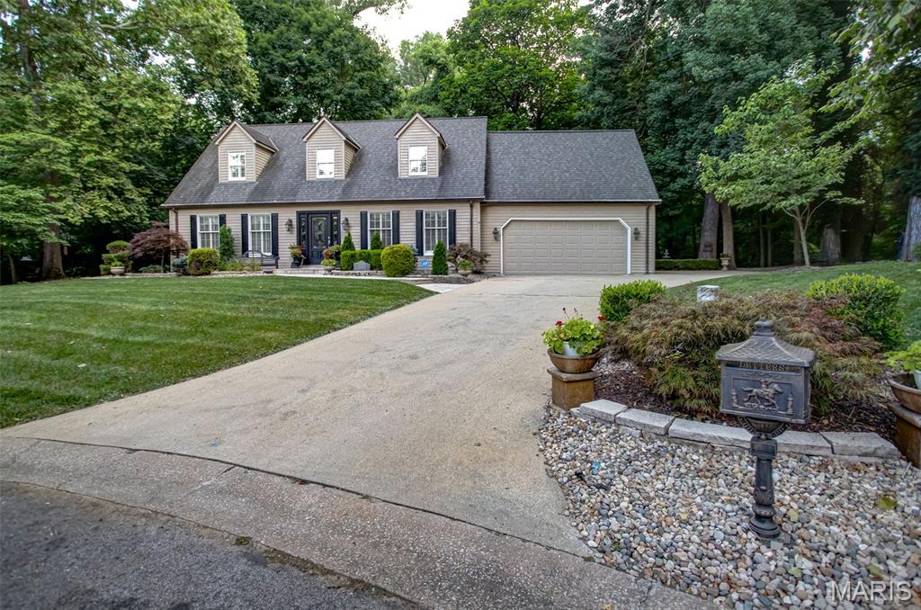 Welcome home to this one-owner, beautifully maintained 4-bedroom, 2.5-bath residence offering timeless elegance, exceptional craftsmanship, and thoughtfully designed living spaces inside and out.

A paver walkway and inviting front porch create a warm welcome as you step into the impressive marble-floored foyer. The private study, complete with custom built-in bookcases, is located to the left, while the formal dining room sits to the right, providing the perfect setting for entertaining.

The spacious living room features a charming bay window, hardwood flooring, and a cozy gas fireplace. The heart of the home is the well-appointed kitchen, showcasing granite countertops, a Wolf gas range, stainless steel appliances, wine cooler,  island, and a convenient wet bar with a second sink. The adjoining laundry/mudroom, located just off the attached two-car garage, includes the washer and dryer, which will remain with the home.

At the rear of the home, you’ll find a stunning sunroom with tile flooring, a second gas fireplace, and a wall of Andersen windows and Andersen French Doors leading to the maintenance-free Trex deck. The stamped concrete patio overlooks a beautifully landscaped, private backyard surrounded by mature trees. Enjoy peaceful outdoor living with an inground sprinkler system (all the way around property), landscape lighting, shade garden, fountain, fire pit, copper gutters that adorn the house and plenty of space to relax or entertain.

Upstairs, a unique 7’ x 10’ wood landing connects three secondary bedrooms and the luxurious primary suite. The largest secondary bedroom offers vaulted ceilings and custom built-in shelving, while another bedroom features a charming reading nook with a corner cubby—perfect for little ones.

The spacious primary suite is truly a retreat, featuring hardwood floors, a vaulted ceiling, electric fireplace, and a charming Juliette balcony overlooking the private backyard. The newly remodeled 10’ x 10’ en-suite bath includes a soaking tub, oversized glass shower, double vanity, and beautiful finishes throughout.

Additional features include a full unfinished basement already plumbed for a future third full bathroom, six-panel wood doors, plantation shutters, attic fan, attached two-car garage with an additional side parking pad, and outstanding curb appeal. In addition to all the amazing features, the Roof new 2012, AC new in 2023, and the Furnace new 12/2025. There is a chair lift currently not installed that can stay with the home and be re-installed for future owners.

This exceptional one-owner home combines classic Georgian architecture with modern comforts, quality updates, and an incredible private setting at the end of a quiet cul-de-sac.  A rare opportunity to own a truly special property that has been lovingly cared for and is ready for its next chapter.