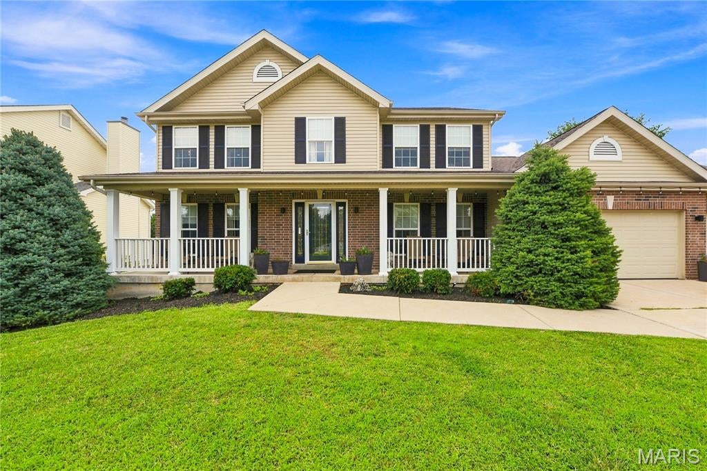 Welcome to Sunshine Brooke Drive. A charming covered front porch, handsome brick facade, and three-car garage create an unforgettable first impression. Inside, spacious living areas and a versatile floor plan are designed to accommodate everyday living, effortless entertaining, and today's work-from-home lifestyle. Sun-filled spaces and warm hardwood floors flow throughout the main level, where a striking open staircase is flanked by a private office and formal dining room. The dining room showcases a custom feature wall, floating credenza, and updated lighting, while the inviting office offers rich designer finishes and opens seamlessly to the family room. The expansive family room is an entertainer's dream with a floating media center, custom shelving, and accent lighting. The adjoining kitchen features a center island, 42-inch cabinetry, stainless steel appliances, deck access, and a convenient main-floor laundry. Upstairs, hardwood flooring continues throughout all four bedrooms, including a spacious primary suite designed as a relaxing retreat with tranquil colors and elegant window treatments. Three additional bedrooms and an updated hall bath complete the upper level. The walk-out lower level offers exceptional potential for future living space with oversized windows, a full bath rough-in, and direct backyard access. Tucked into a desirable setting with backyard privacy and natural surroundings, this home offers the perfect balance of comfort, style, and location.
