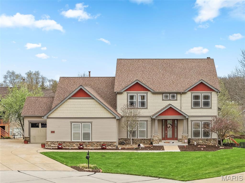 Tucked away on a private cul-de-sac in the highly desirable Fox Haven Subdivision, this custom-built Vantage home offers over 4,300 sq ft of thoughtfully designed living space on a half acre lot. From the moment you arrive, the elevation and professional landscaping create standout curb appeal. Inside, a light- filled floor plan unfolds with soaring ceilings in the Great Room, where a striking stone fireplace, built-in niches, and transom windows create a warm yet open gathering space. Hardwood flooring flows through the main areas, leading into a well-appointed kitchen featuring custom cabinetry, crown molding, a tile and mosaic backsplash, and ample space for both everyday living and entertaining. The main-floor primary suite provides a private retreat with a coffered ceiling, transom windows, and a walk-in closet with custom built-ins. Main floor office with closet and french doors can be used as a 5th bedroom. Upstairs, three additional bedrooms offer flexible living with a Jack & Jill bath, private ensuite, and a spacious bonus room ideal for a media space, office, or playroom. The walkout lower level offers a 9-foot pour, abundant natural light, and a partially finished layout with room for recreation, fitness, and storage. Composite deck overlooking a private backyard that would be perfect for a future pool! Located in the Francis Howell School District, this home also offers a rare natural backdrop—backing to Busch Wildlife and just steps from the Busch Wildlife Conservation Area for unmatched privacy and outdoor access. All of this with convenient access to Winghaven and Hwy 40/61/364.