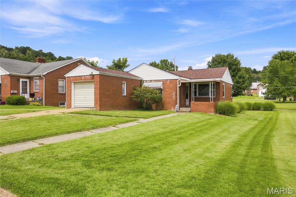 Welcome to this charming 3-bedroom, 1-bath home in a desirable, walkable residential area of Hermann! Situated on a level lot with partial fencing, this home offers a convenient location just one block from the school and only a couple of blocks from the city park. Sidewalks make it easy to enjoy the neighborhood and nearby amenities. The home has been well cared for and features beautiful wood floors, an attached garage, and a newer roof. The full unfinished basement provides plenty of storage space and potential for future use. One of the three bedrooms includes laundry hookups, giving you the option for convenient main-level laundry. With its comfortable layout, great location, and easy access to schools, parks, and the community, this home is a wonderful opportunity to enjoy all that Hermann has to offer!