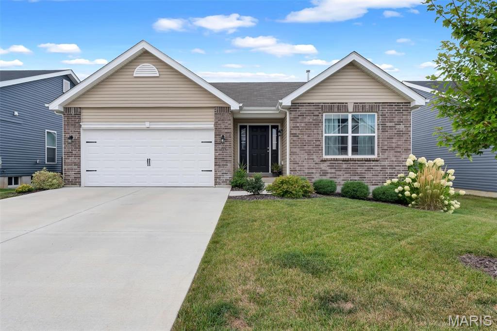 Beautiful move-in ready home featuring 4 bedrooms and 3 full bathrooms. The open-concept floor plan offers a vaulted ceiling, spacious great room with a electric build in fireplace and durable wood laminate flooring throughout the main living areas. The kitchen is beautifully appointed with white cabinetry, , a peninsula with an extended breakfast bar and a sliding glass door leading to the backyard. The primary suite includes a ceiling fan, walk-in closet, and private bathtoom. Two additional bedrooms and a full hall bath provide plenty of space for guests. The basement has recently been finished and the back yard has a large 16' x 24' patio—creating the perfect space for entertaining or accommodating overnight guests. Located in the desirable Westhaven community within the highly rated Wentzville School District, this home offers quick access to Highway 61, Interstate 70, and Highway 40, making commuting a breeze.