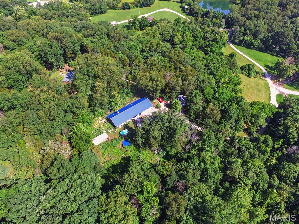 WELCOME TO YOUR PRIVATE UNIQUE OASIS.  HAS A SPRING RUNNING THROUGH THE  5.48 ACRES.  THE HOME IS 1,689 SQUARE FEET. OPEN FLOOR PLAN, ATTACHED OVERSIZED 3 CAR GARAGE, ENCLOSED PORCH, GAZEBO, AND AN ABOVE GROUND POOL. THIS IS A ONE OF A KIND PROPERTY. NEAR TO AMUSEMENT PARK AND I-44 CORIDOR. 
PRIVATE SHOWINGS AVAILABLE.  NOT A DRIVE BY. MUST SEE. TOO MANY AMENITIES TO MENTION.