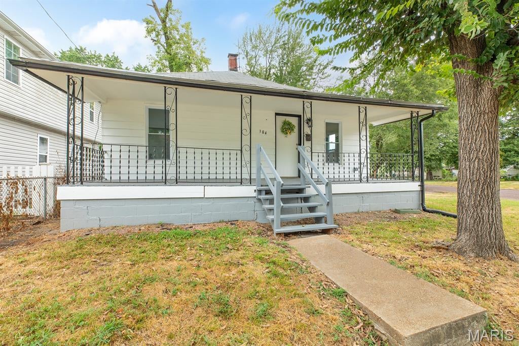Take a look at this beautifully renovated 2-bedroom, 1-bath home on a corner lot in East Alton! So many updates have already been completed, including all new electrical, plumbing, HVAC, water heater, flooring, drywall, etc. The kitchen features new cabinets with soft-close doors and quartz countertops, while the updated bathroom offers a custom-tiled shower and new vanity. The home has 9' ceilings, crown molding, and plenty of character throughout. A large bonus room overlooking the backyard gives you so many options—it could be a playroom, game room, office, bar, sitting room, or whatever works best for you. Outside, you'll find a large backyard shaded by a large tree and an oversized 2-car garage with additional driveway parking. With the major updates already taken care of and plenty of flexible space, this home is ready for you!