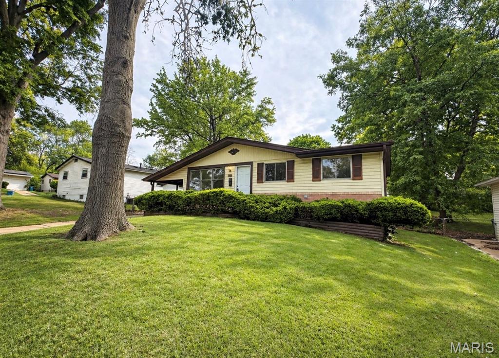 This well-maintained 3-bedroom, 1-bath home delivers comfortable living with thoughtful updates and added space to enjoy. The main level features durable laminate flooring throughout the living areas, creating a clean and cohesive feel, while the bright living room offers a welcoming space to relax or entertain. The eat-in kitchen is generously sized with plenty of cabinetry, making meal prep and everyday living easy and efficient. All three bedrooms are nicely sized with brand-new carpet, including a spacious primary, and are conveniently located near the full bath.  The fully finished lower level adds valuable extra living space with a large family/recreation area and additional rooms that can be used for guests, a home office, or hobby space. An unfinished section provides room for storage and laundry.  Outside, enjoy a fenced backyard perfect for pets, play, or outdoor gatherings, along with the convenience of a 1-car carport. A great combination of space, functionality, and comfort—ready for its next owner!