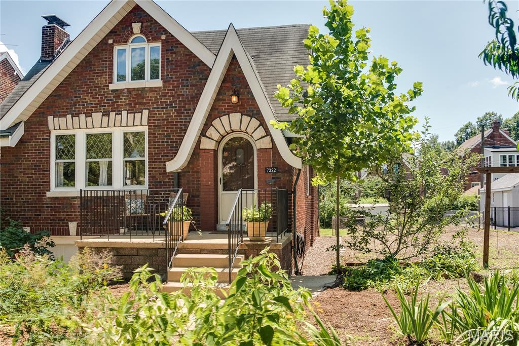 Wonderful opportunity in a charming enclave of U city. This well maintained  early 20th century 4 bedroom full brick home has many great features. Original hardwood flooring throughout the main level and many stained glass windows express that the character of this home is difficult to reproduce. Walk up the curved path past many perennials then  enter through the archtop solid woof door with speakeasy motif you’ll be presented with a stone hearth with limestone mantle, and original diamond leaded glass front windows  next through the gothic arch is the dining room with lots of natural light and included chandelier and cafe sheer curtains. The spacious kitchen is in the rear of the house with its own exit to the porch and features a gas range built-in dishwasher plenty of cabinet and pantry storage and a butcherblock like Formica countertop, a rolling true butcherblock table/work surface with stainless steel base is included. 2 Bedrooms on this main level are separated by a full bath in well-maintained period black and white tile floors and walls. Upstairs are 2 more bedrooms with gleaming wood flooring, lots of natural light through upgraded windows, lots of closet space and storage. An upgraded half bath rounds out the second level. The lower level is clean and bright, ready for extra living space due to the walk-out and plenty of storage. You’ll be sure to notice the masonry ceilings that create a solid foundation There is a one-car tuck under garage with automatic door opener. Outside is a double lot with huge side yard with improved soil by the current owner for your own vegetable garden of create a thriving lawn for your enjoyment. There is an included green house. Close to Heman Park, and easy access to new U city developments -- Target, Costco, Dierbergs, many new restaurants and amenities. Be part of the revitalization of U city’s Olive Boulevard corridor.