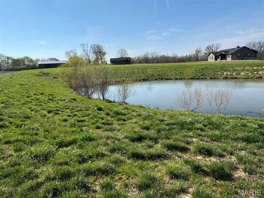 Located just east of Highland, this beautiful 2-acre lot sits at the end of a quiet cul-de-sac in a newer subdivision, offering both privacy and a great setting to build your dream home. The property features a small pond, adding a peaceful and scenic touch that makes it stand out from typical building sites.

With no HOA fees, you’ll have more freedom and fewer restrictions while still enjoying the benefits of a well-kept neighborhood. Conveniently located about 30 minutes from St. Louis, this property gives you the perfect balance of country living and easy access to city amenities.