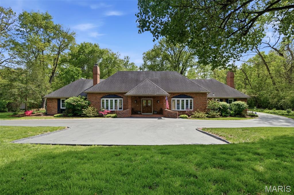 Enjoy a serene, blissful setting in the heart of Ladue. From the moment you enter this sun-filled home, you’re welcomed by peaceful views of the lush backyard. The entry is flanked by a formal dining room on one side and an inviting sunken living room on the other, complete with built-ins and a fireplace—an ideal setting for both lively gatherings and cozy, timeless evenings at home. The entire main level has been freshly painted, creating a bright, refreshed feel throughout.

The private Main-floor owner’s suite features an expansive custom walk-in closet and an updated bath with a luxury jetted tub and curbless-entry shower. A second main-floor ensuite offers an updated bath with a large double vanity—ideal for nursery, guests or multi-generational living.

The fabulous, updated open kitchen and hearth room—with a striking stone fireplace—truly serve as the heart of the home. A classic center hall layout connects the spacious living and dining rooms, all adjoining the impressive 50-foot terrazzo gallery, making this home perfect for entertaining. 

Upstairs, you’ll find two generously sized bedrooms and an updated full bath. Additional highlights include main-floor laundry and a versatile lower level, ideal for storage, a cedar closet, or playroom.

The gallery opens to a charming brick patio overlooking a level, wooded lot—your own private retreat. A large circle drive and additional parking pad add convenience.

This home is a unique architectural delight in the fabulous Forest Green neighborhood. Enter from Old Warson Road.