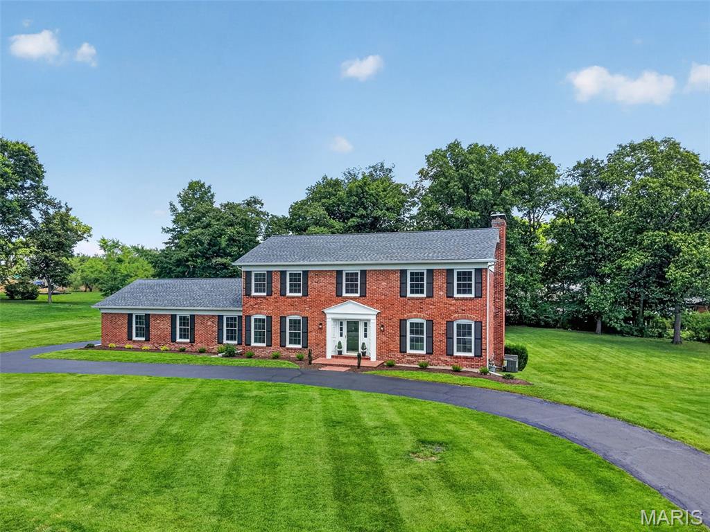 Stunning, fully renovated Town & Country estate situated on a level, open, one-acre lot. The exquisite chef's kitchen boasts exceptional cabinetry, a center island with seating, quartz countertops, premium GE Cafe appliances including a commercial gas range, and a spacious, sun-lit butler's pantry. Flowing effortlessly from the kitchen, the formal dining room provides an elegant space for daily use or hosting. Unwind in the great room in front of the wood-burning fireplace flanked by built-in bookcases, and enjoy the convenience of a stylish wet bar.

Upstairs, the luxurious primary suite serves as a private sanctuary alongside three additional bedrooms. The redesigned primary bath offers ultimate modern convenience, featuring a fully tiled walk-in shower with a traditional shower head and handheld sprayer, a beautiful freestanding soaking tub, and lighted, defogging mirrors. The walk-in closet elevates luxury living with custom built-ins and its own wood-burning fireplace. Downstairs, the walk-out basement provides an additional 1,000 square feet of finished living space and convenient unfinished storage. The backyard is a blank slate ready to be transformed into your own outdoor oasis. Beyond the beauty, you have peace of mind with new windows throughout, a new roof, and one new HVAC system.