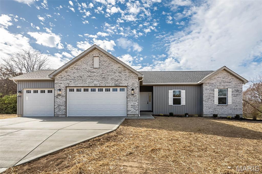 Brand new ranch home on nearly 3 acres of level, private ground—ideal for a future pool, detached garage, or simply enjoying wide open space. Located in a low-restriction, 21-lot development with homesites ranging from 3 to 6 acres, this is the closest new home subdivision off blacktop near town with public water and easy access to amenities. Thoughtfully designed and packed with upgrades, this home features nine-foot ceilings on the main level and a full nine-foot pour in the lower level, an oversized three-car garage, bay window, walk-out patio, and a beautiful brick and board-and-batten exterior with architectural shingles. Inside, you’ll find high-grade luxury vinyl plank flooring, a full stone woodburning fireplace, and real custom cabinetry with crown molding. The kitchen offers quartz countertops, upgraded appliances, and plenty of workspace and storage. Main floor laundry adds everyday convenience. The primary suite includes his and hers closets, a double adult-height vanity, and an oversized walk-in tile shower. The lower level is ready to grow, with an egress window and full bathroom rough-in already in place. Offered at a builder spec discount, this home delivers exceptional value in a premium setting.