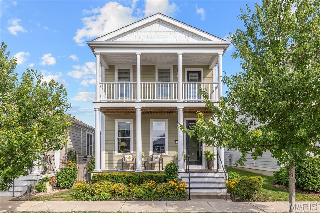 Exceptional 1.5 Sty located in the sought after Gateway District of New Town at St. Charles. This well-planned home features an open layout designed to accommodate daily comfort & gracious entertaining. Welcoming porch entrance highlighted by architectural columns leads to spacious living room with full-height windows, adjacent dining area and chef’s kitchen with Cambria quartz countertops, upgraded cabinetry with transom cabinets, stainless steel appliances & 11’ peninsula with raised breakfast bar. The primary bedroom suite with walk-in closet & ensuite bath provides an appealing retreat. A convenient laundry & powder room complete the main floor living quarters. The second level includes 2 additional bedrooms, full bath & a generous-sized bonus room with atrium door that opens to covered balcony. This walkable community affords the convenience of neighborhood shops & restaurants plus stocked lakes, canals, waterpark & amphitheater.