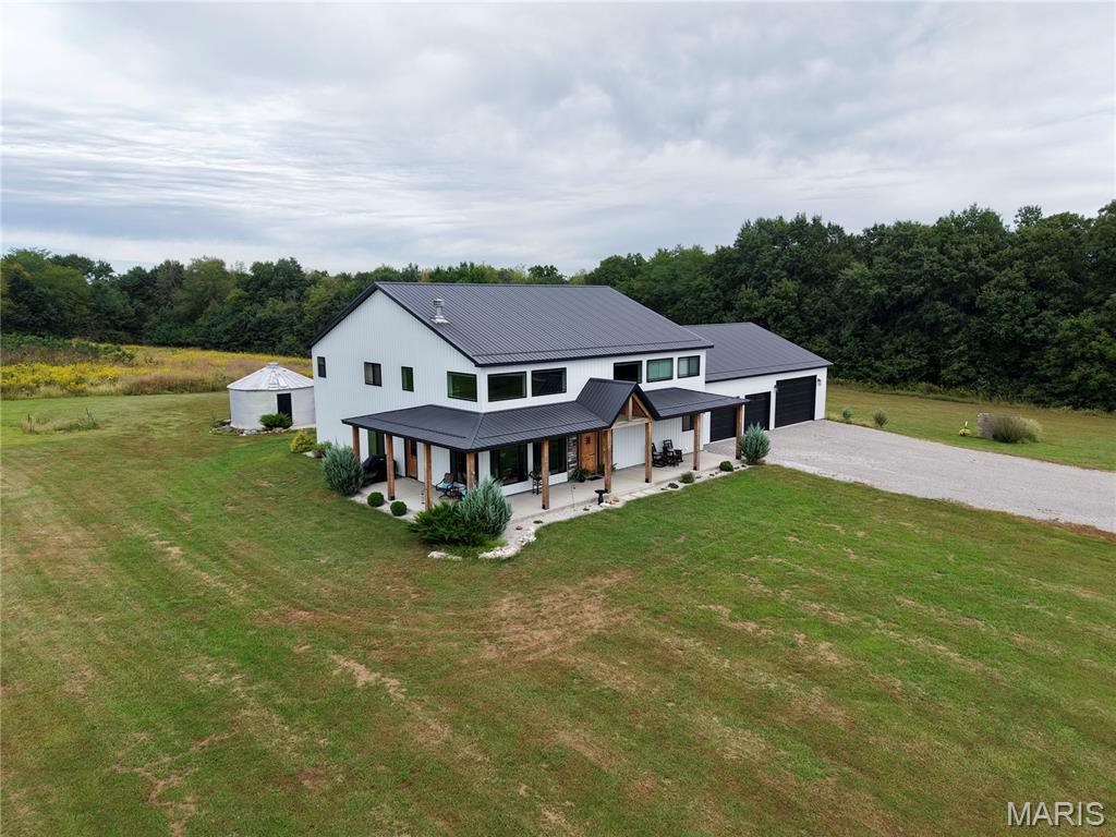 Located in the Ralls County school district, this property includes three living areas, trails, and 14.81 acres of land. The custom-built residence offers 4,032 sq ft of living space and an attached 40x50 shop, totaling just over 6,000 sq ft. The spacious gathering room features 18-foot wooden ceilings and a floor-to-ceiling wood-burning fireplace, while 9-foot ceilings and large windows bring in natural light.
The open-concept kitchen includes an 11-foot island, custom alder cabinetry, a hidden pantry, and a 48-inch gas range. With three bedrooms, three bathrooms, a mudroom, and a flexible room for an office, den, or extra sleeping area, comfort is key.
Two more living areas, including a bar and recreation room, provide space for relaxation. Outside, a covered porch features a cooking station, a grain bin bar, and trails through the landscape.
The shop has 12-foot ceilings, storm shelter, a wood-burning stove, and a second kitchen with stainless counters. With geothermal heating, spray foam insulation, and metal siding and roofing, the residence is well-crafted.