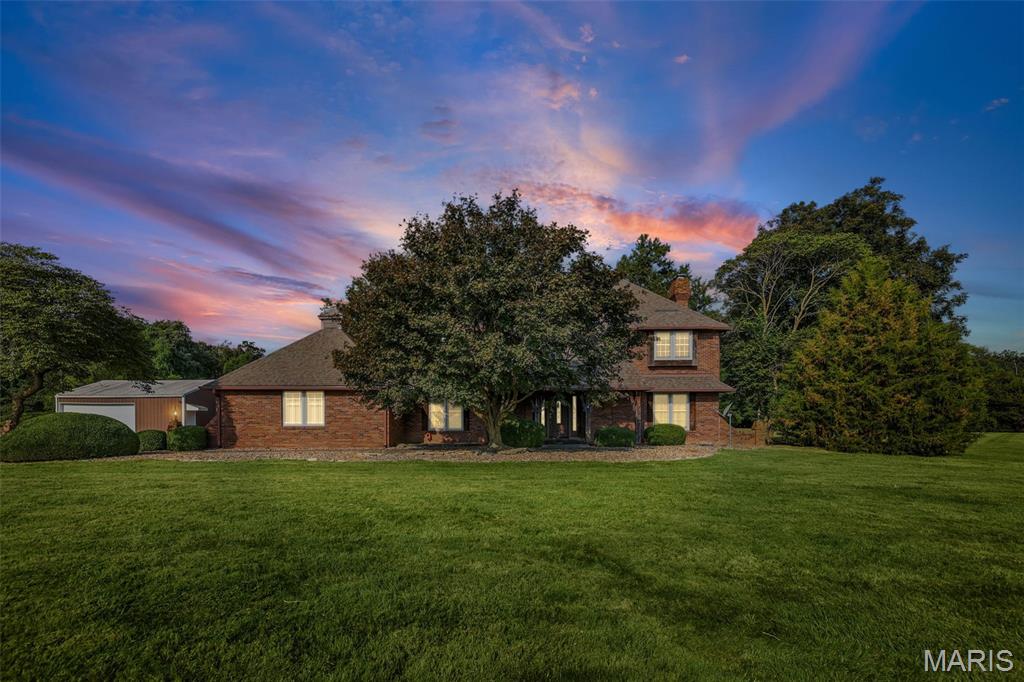 20+ acres in Triad School District with endless possibilities! Plenty of space for a homestead, hunting, fishing, farm life, outdoor entertaining, cycling all just a short distance from major highways and shopping centers. All brick sturdy one owner home with hardwood floors throughout, high end kitchen appliances, and many gathering spaces has room for everyone. Over 4000 sqf with sunken living room, formal dining room, two primary bedroom en suites, main floor (ADA) and upper-level gives flexibility and freedom along with 3 additional upper-level bedrooms. Family room features wood burning fireplace surrounded by stone, beautiful view of the back yard/courtyard, and built in wet bar. Lower-level recreation area with additional stone wall wood burning fireplace provides the ultimate flexible space with infinite potential. Lots of storge areas: detached 25x30 garage and large pole/stall barn on property. Outdoor brick courtyard provides privacy and tranquility to enjoy all the natural beauty this property offers. Private bike path entrance towards back on main lot with over 8 acres of woods to explore across the path. This amazing property checks so many boxes! Home sold 'as is.'