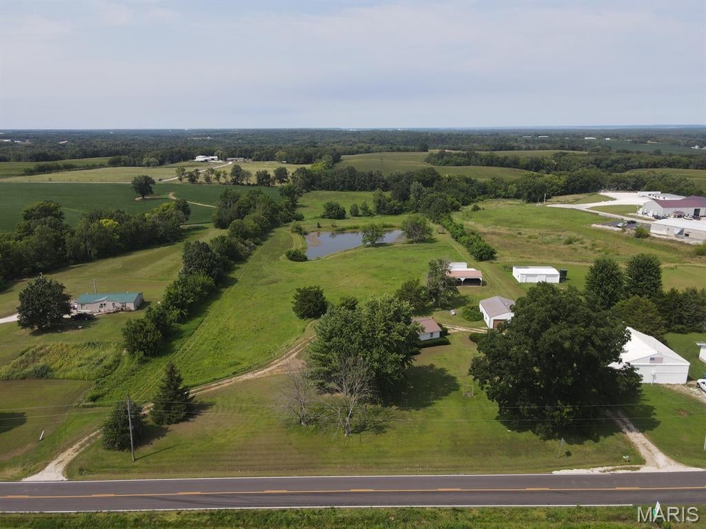The back deck views here make you want to stay awhile - overlooking the sprawling back yard, fields & lake, this 10-acre tract is your getaway, while not having to be far away!  Located on the west edge of LaGrange, take advantage of town amenities and a great location just off Hwy 61, with all the perks of country living.  Big front & back yards, wraparound deck and the perfect lake for summer gatherings.  An old grain bin has been converted into a covered patio, with shade trees offering the ideal getaway on summer days.  The home has been well-maintained and is move-in ready with room to make it your own! This 2-bed, 2 bath home (was 4-bed) has been cared for and shows pride of ownership throughout. Featuring an open floor plan, sunny interior, spacious master, and updated bathroom with walk-in shower, it's ready for your personal touch and modern finishes to build instant equity.  The main level offers bonus rooms that could be converted to another bedroom on the main level.  The full walkout basement houses the utilities and another full bathroom, and could easily be finished out for more living space.  The 2-car garage offers plenty of parking and already has finished workshop space, and the 40x45 2-bay metal utility shed offers additional parking & storage.  You'll love the outdoor space here - a spread like this is hard to find, especially in this location!

Utility providers here include Ameren Electric, City water & trash, septic tank, Brightspeed Internet, and the propane tank is owned.  Located in Lewis County C-1 School District and a short drive to either Canton or Quincy.
