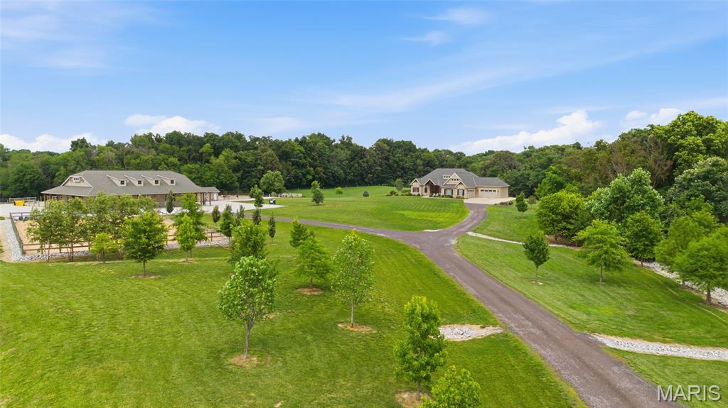 Beautiful Horse ranch situated on just over 10 acres offering an incredible combination of luxury, privacy, entertaining space, and equestrian amenities. Built in 2018, the custom home features an impressive 4,888 sq. ft. of finished living space with 5 bedrooms and 3.5 bathrooms.
The main level features 3 bedrooms and 2.5 bathrooms, including two bedrooms connected by a convenient Jack-and-Jill bath. The spacious primary suite offers large dual closets, a soaking tub, and a beautiful walk-in shower.
At the heart of the home, the kitchen features ample modern cabinetry with quarts countertops and opens seamlessly into the living room, making it perfect for everyday living and entertaining. The dining room is accented by beautiful coffered ceilings and custom details that continue throughout the home.
The finished basement provides even more living space with 2 additional bedrooms, a full bathroom, and a spacious living room, along with a separate storage area. 4 car attached garage. 
Outside is where this property becomes truly special. The full masonry horse barn features 5 stalls, a tack room, a bathroom and an additional garage/workshop area on the opposite side. Upstairs, you’ll find a finished entertainment space, creating the perfect setting for parties, gatherings, or hosting family and friends.
The property also includes a riding ring and pasture, making it an exceptional setup for horse owners.
Enjoy peaceful country views, 10 acres of space, and the privacy of country living—all within the Columbia School District.
