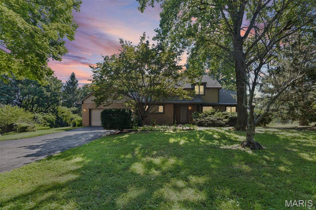 Nestled on 5 picturesque acres, this charming 3-bedroom, 2.5-bath home offers the perfect blend of peaceful country living, everyday comfort, and quick convenience to anything you need. Step inside to find beautiful hardwood floors and ceramic tile throughout the main level, creating a warm and inviting atmosphere. The spacious kitchen features elegant quartz countertops, stainless steel appliances that stay, and a cozy breakfast nook overlooking the property. The main floor also offers a welcoming living room, separate formal dining room with french doors leading to the side yard, a convenient laundry room, half bath, and a comfortable family room. The family room is highlighted by a wood-burning fireplace that can easily be converted back to gas and atrium doors leading onto the deck. Step outside onto the back deck and enjoy tranquil views of your private acreage.

Upstairs, you'll find two generously sized bedrooms, a full hall bathroom, and a spacious primary suite complete with a sitting area and its own private bath. The unfinished walkout basement provides endless possibilities for future living space, a workshop, or additional storage.

Outside, you'll love the beautifully maintained grounds featuring mature trees, colorful flowerbeds, a thriving garden, and a large open area perfect for recreation, animals, or entertaining. A large detached outbuilding offers exceptional space for hobbies, equipment, or additional storage. This rare property combines the serenity of country living with the functionality you are looking for—don't miss your opportunity to make it your own!