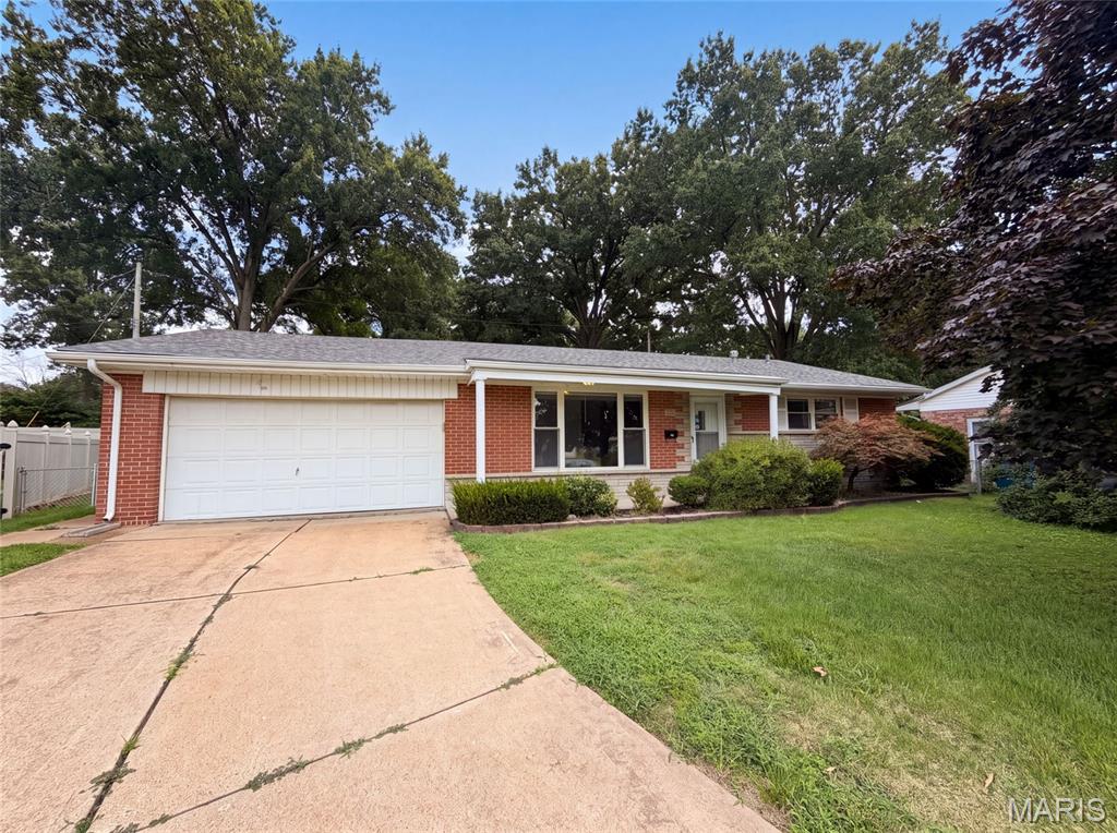 871 Wycliffe Ct is a one-story Saint Louis home situated on a cul-de-sac lot, offering three bedrooms and a full bathroom plus a half bath. The kitchen features white cabinetry, stainless steel appliances, and ample counter space, opening into a tile-floored living area with sliding glass doors leading outside. The bedrooms offer wood flooring and closet storage throughout. A finished lower level adds a spacious recreation room for additional living space. Outside, a deck overlooks the backyard, and a two-car garage completes this well-maintained residence with practical amenities throughout every room. Included 100-Day Home Warranty with buyer activation
