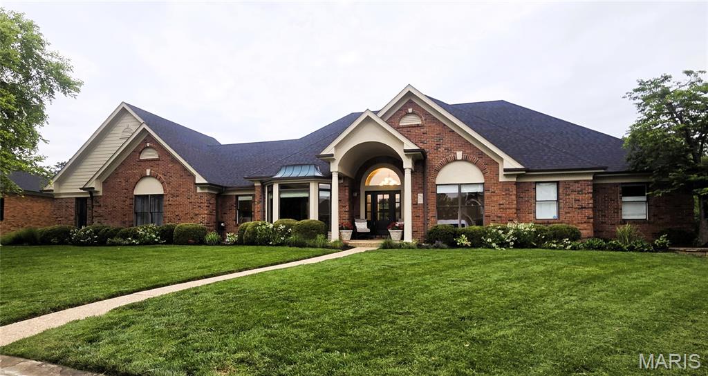 Welcome to 403 Thorntree Lake Court, a truly exceptional all-brick ranch with a heated in-ground pool and breathtaking lake views in the highly sought-after The Legends Golf Community. Offering more than 4,600 square feet of beautifully finished living space, this stunning, custom-built 5-bedroom, 3.5-bath home is perfectly situated on a meticulously landscaped 0.47-acre cul-de-sac lot.
From the moment you arrive, the home’s outstanding curb appeal sets the tone. A covered front porch welcomes you into a light-filled foyer, flanked by an elegant formal dining room featuring a coffered ceiling and extensive crown molding. The spectacular great room showcases 12-foot coffered ceilings, rich wood floors, a striking gas fireplace, and dramatic floor-to-ceiling windows that frame the spectacular backyard and lake beyond.
The gourmet kitchen is designed to impress, featuring newer crisp white 42-inch shaker soft-close cabinetry, granite countertops, and newer stainless steel appliances, including a 5-burner gas cooktop, two double ovens and a walk-in pantry. The sun-drenched breakfast room stars a distinctive shiplap ceiling and bay windows create the perfect setting for everyday living while capturing panoramic views of the pool and lake. Plantation shutters provide both privacy and timeless style.
The luxurious main-floor primary suite is a private retreat, complete with a coffered ceiling, serene lake views, a spacious walk-in closet with custom organizers, and a beautifully renovated spa-inspired bath featuring dual vanities, a walk-in tiled shower, and a freestanding soaking tub.
Two additional main-floor bedrooms share a renovated Jack-and-Jill bath, while a spacious laundry room with abundant storage and a powder room complete the main level.
The finished walk-out lower level is ideal for entertaining and flexible living, offering a large family room with  two additional bedrooms, a full bath, space for a home gym, study space, and substantial unfinished storage.
Step outside to your own resort-style backyard oasis. Enjoy peaceful lake views and abundant wildlife while relaxing in the heated pool or entertaining on the expansive pool deck.
Additional highlights include an oversized 3-car rear-entry garage and numerous recent updates, including a newer roof, furnace, carpeting throughout (2026), pool fence (2026), concrete driveway (2026), and matte black door hardware throughout (2026).
Residents of The Legends Golf Community enjoy outstanding walking trails, and scenic lakes.
This extraordinary home combines timeless craftsmanship, luxury finishes, and an unbeatable waterfront setting—an exceptional opportunity in one of the area’s premier communities. Located in the Award-Winning Rockwood School District.