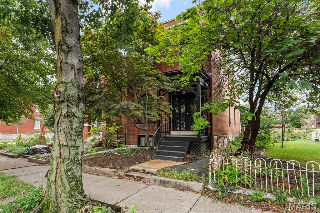 Beautiful 2-story brick home in the Grove! This home features 2 bedrooms, 1.5 bathrooms and tons of charm. The large covered front porch welcomes you into the spacious living room with a decorative brick fireplace. Just past the living room you will find a formal dining area or additional sitting room that wraps back to the kitchen. Be sure to notice the gorgeous exposed brick and new flooring throughout. Kitchen is bright with plenty of white cabinets offering tons of storage and a butcher block countertop giving this room a modern look. Completing this main level is a convenient half bath located between the kitchen and dining room. Upstairs you are first greeted with a large sitting room featuring built-in shelving making this space perfect for a library/den or home office with direct access to the full bathroom. The bathroom boasts a double vanity with lots of storage, a step-in shower and separate soaking tub all with updated hardware. Completing this upper level are 2 nicely sized bedrooms with access to the unique multi-level solarium. The walk-out basement is partially finished with a laundry area and tons of space for all your storage needs. Enjoy a relaxing day in the solarium that looks out to the fenced backyard that is perfect for any sort of garden you desire. Be sure to make your appointment today to come check out the charm this home boasts throughout every corner!