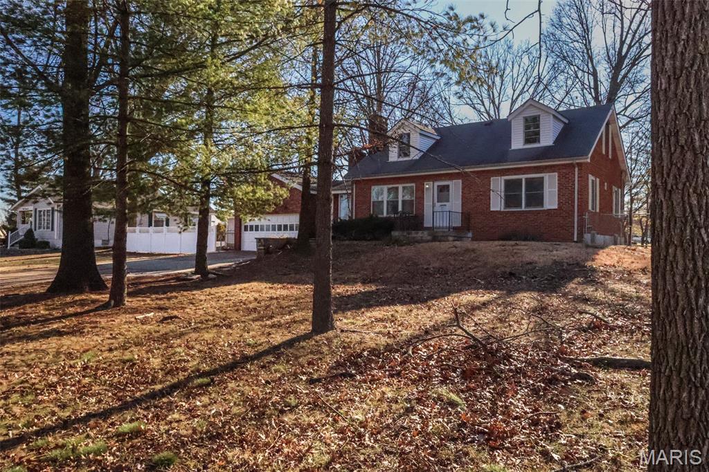 This home has tons of character and is located in the heart of EVERYTHING!  The interior features hardwood floors and arched doorways. The kitchen has granite countertops and a large pantry!  The bonus room off the kitchen could be a home office, playroom, work-out room, or whatever you need it to be. The sunroom overlooks the large back yard with a fire pit. The basement is open and provides an abundance of storage. The oversized garage is 26' deep so will accommodate, cars, toys, or a workshop.