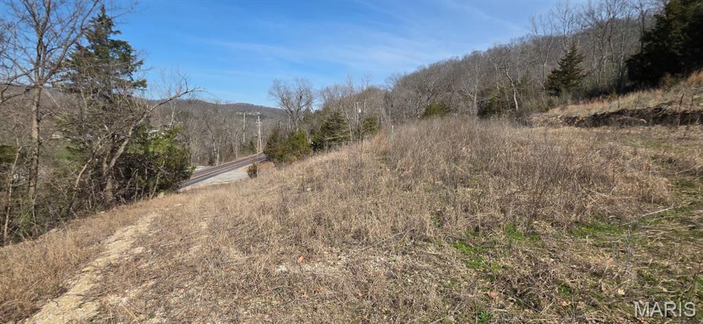 Build your dream home on this 6.49-acre High Ridge retreat, complete with stunning rolling hillside views, abundant trees, and privacy… plus a valuable head start on development. Extensive improvements are already in place: clearing, grading, drainage work, rock excavation, a widened driveway entrance, expanded access road, culvert installation, and additional leveling to maximize usable space. Water, septic, and electric are all available, with the water line located and ready for meter installation and the septic system already marked. Multiple buildable areas offer flexibility for a home, shop, pole barn, or outdoor retreat. No HOA or subdivision restrictions mean you're free to create the lifestyle you've envisioned. Enjoy gorgeous views and peaceful surroundings while staying close to shopping, dining, and Hwy 30. Bring your builder and your vision, and come see your new home today!