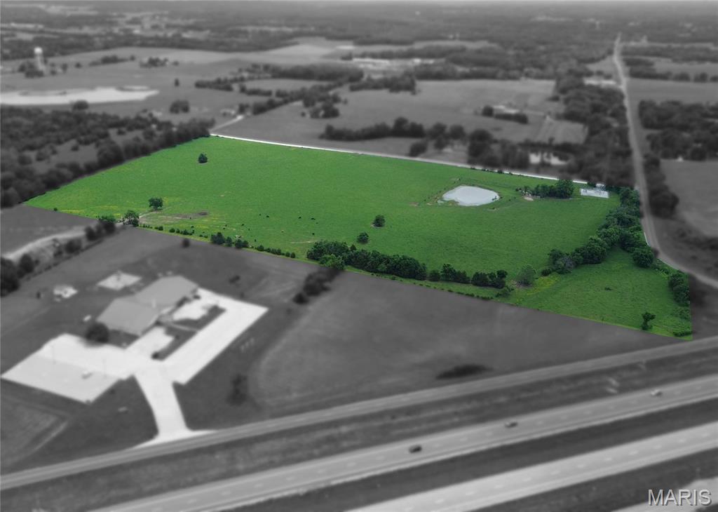High-visibility 35-acre tract just off Highway 54 at the State Road H exit. Here's your opportunity to own a highly visible 35-acre tract located just off Highway 54. High-visibility. Prime corner location at State Road NN and the Outer Road of Old Hwy 54 with additional rear access from County Road 404. Located outside Fulton city limits with no City zoning ordinances. Allowing flexibility for commercial, industrial, or development use. Rolling terrain with excellent exposure and easy to the State Road H exit. access. County water and electric available, with potential for county sewer connection. Ideal site for business, industrial park, or mixed-use development in a growing corridor. This strategically positioned property offers exceptional exposure and convenient access.