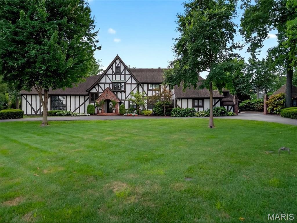 Step into timeless sophistication as old world charm seamlessly blends w/ modern-day luxury in this exquisite 5397 sqft residence. Upon entering, you’re greeted by a grand LR featuring vaulted wood-beamed ceilings, leaded glass windows,& stunning boxwood paneling. The family room offers gorgeous custom wood shelving, soaring ceilings,& a stylish wet bar—perfect for entertaining. A striking see-through fireplace connects this space to the elegant billiards room. French doors open to both an open-air porch & a beautifully landscaped yard with a sparkling PebbleTec pool & patio. The formal DR impresses w/ its rich millwork, boxed panel walls, beamed ceilings, & gleaming hardwood floors—all w/direct access to the pool/patio, ideal for indoor-outdoor entertaining. The chef’s kitchen features a large center island, quartzite countertops,& abundant storage. It opens to a cozy hearth room w/ a fireplace & access to the rear patio. A 1st floor bedroom/office with a full bath, a laundry room,& a convenient 1/2 bath complete the main level. Upstairs, the gracious primary suite offers a generous walk-in closet & an elegant en-suite bath. 3 additional bedrms & 2 full baths provide ample space & comfort for family/guests. The partially finished LL includes a full bath & a rec area, perfect for a home gym or media space. Add'l highlights include a 3-car garage, over 1.1 acres of professionally landscaped grounds, and a stunning PebbleTec pool, landscape lighting & irrigation system.