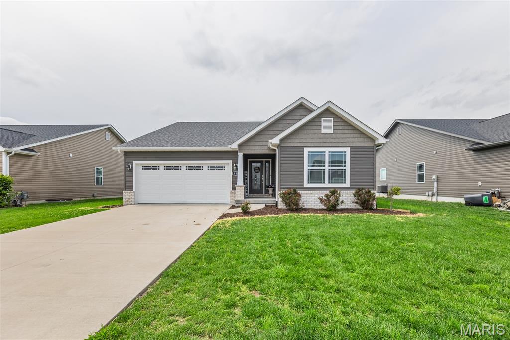 Welcome to 811 Topaz Ct in Mascoutah, IL. This home was built in 2022 and offering over 3,000 sq ft of beautifully finished living space. This stunning Dakota floor plan ranch sits on a full finished basement and is completely move-in ready. Step inside to an open floor plan designed for both comfort and entertaining. The kitchen stands out with granite countertops, a large island, plenty of cabinet space, and a walk-in pantry. It flows right into the dining area with a cathedral ceiling and into the spacious living room featuring a cozy gas fireplace with flat screen TV. The main level includes a generous primary suite with a private bath offering a separate tub and shower, dual vanities, and a walk-in closet. You’ll also find additional bedrooms that are well-sized and functional. Downstairs, the fully finished basement adds even more space with a fourth bedroom, full bathroom, and a large open living area, perfect for guests, a second family room, or a home office setup.
Step outside to the covered 16x14 patio, a great spot to relax, or hosting gatherings. Tucked away on a quiet cul-de-sac and just minutes from Scott Air Force Base, this home gives you the space, layout, and newer construction feel buyers are looking for without the wait. You don’t want to miss this one. Buyer to verify all information.