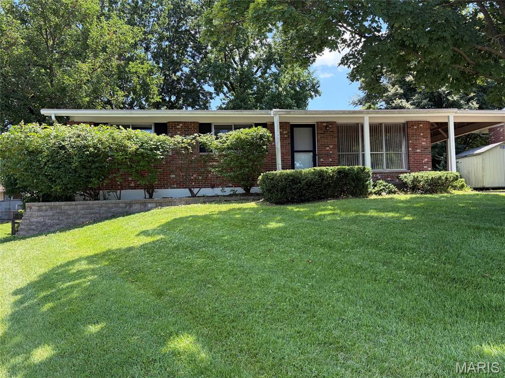 Beautiful all-brick home in South County, ideally located near highly-rated schools, major highways, and shopping.  This property offers a spacious living room, eat-in kitchen with a full suite of appliances, three bedrooms, and one bath. All bedrooms feature carpet with original hardwood flooring underneath.  Additional features include a walk-out basement, ready for your custom design, plumbed for a full bath, 1 car carport, fenced backyard and a welcoming covered front porch.  This home is move-in ready and can accommodate a quick closing.