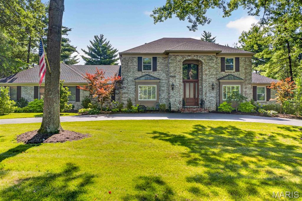 Exceptional Frontenac Woods residence set on a beautifully landscaped one-acre lot within the award-winning Ladue School District. Thoughtfully expanded and extensively renovated, this remarkable home seamlessly blends timeless design with modern comfort, offering a rare combination of elegant living spaces, a main-floor primary suite, a finished walk-out lower level, a resort-style backyard, and a three-car rear-entry garage.

A gracious entry introduces sophisticated yet comfortable interiors filled with natural light, rich hardwood flooring, and beautifully proportioned living spaces designed for both everyday living and effortless entertaining. At the heart of the home is a stunning expanded kitchen featuring generous workspace, a large walk-in pantry, a built-in planning station, and seamless flow to the surrounding gathering areas. The adjoining family room is anchored by a striking floor-to-ceiling stone fireplace, creating a warm and inviting focal point.

The spacious main-floor primary suite serves as a private retreat, offering hardwood floors, a walk-in closet, and a beautifully updated bath. Upstairs, hardwood flooring extends throughout all bedrooms and hallways, complemented by fully renovated baths and enhanced comfort provided by a dedicated third HVAC system.

The finished walk-out lower level significantly expands the home's living and entertaining capabilities, featuring a recreation area, kitchen space, updated bath, gas fireplace, and direct access to the outdoor amenities—ideal for hosting guests, poolside gatherings, or multi-generational living.

Designed for year-round enjoyment, the backyard offers a true resort-like setting. An inground saltwater pool, pergola, raised garden beds, lush landscaping, and expansive patios create a private outdoor sanctuary rarely found in such a central location.

Extensive updates throughout the home include Hardie Board siding, replacement windows, enhanced insulation, upgraded mechanical systems, a custom entry door, and numerous thoughtful improvements that reflect meticulous ownership and pride of maintenance.

Perfectly situated in one of Frontenac's most desirable neighborhoods, this exceptional property offers privacy, convenience, and an unparalleled lifestyle just moments from premier schools, shopping, dining, hospitals, and major commuter routes.