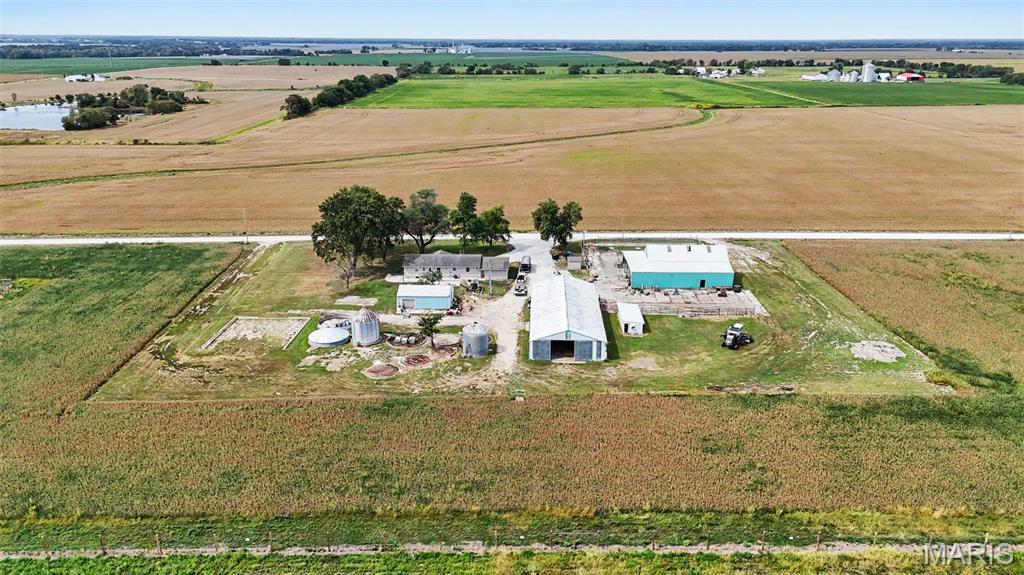 Discover the potential of this 1980 custom built ranch, featuring 4-bed, 1.5-bath, with abundance of garage/shop and barn space! The home offers a sturdy structure, ready for your personal touches and updates to make it truly your own. The lower-level adds valuable versatility with a second kitchen, convenient for entertaining, food prep, canning, or creating additional living space. Outside, scattered mature trees provide shade from the westward sun, while adding a private setting with no neighbors in sight. Outer buildings include an insulated 24x36 Morton building with concrete floor, 45x104 Morton building with concrete foundation and gravel floor, 60x70 barn with concrete floor and loft, and a smaller shed that was used for farrowing. So whether you need the extra space for livestock, equipment, recreational toys or hobbies, this property offers an expansive amount of space.
