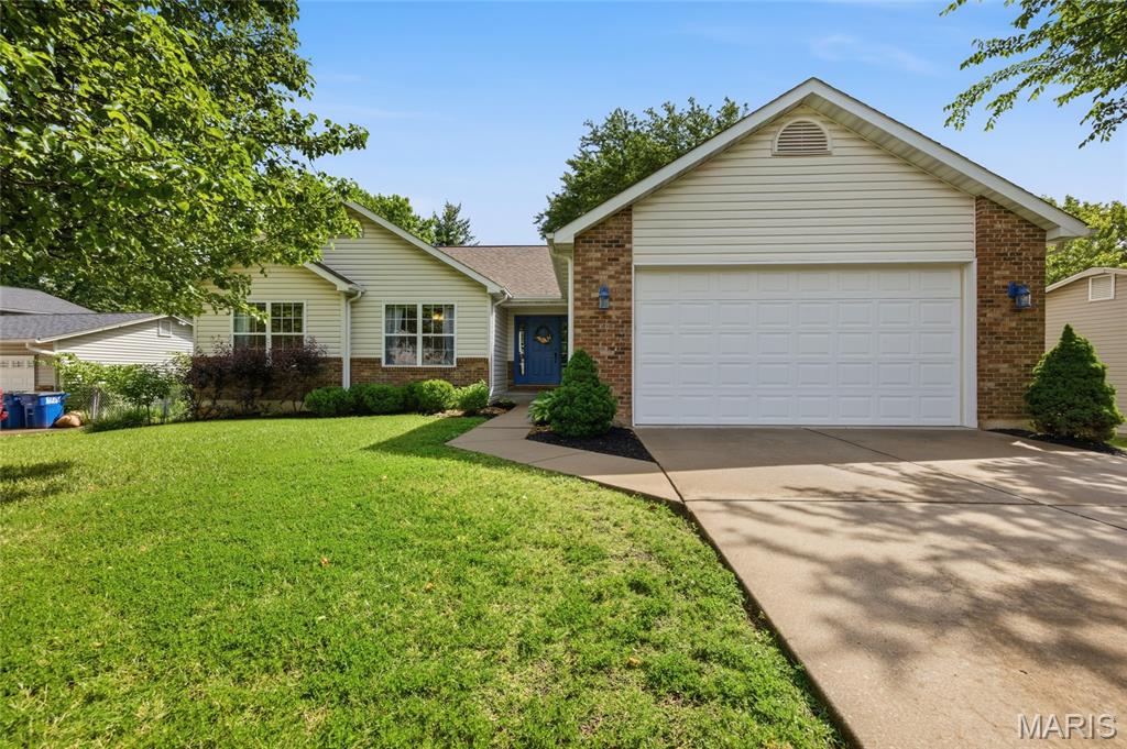 Welcome to 20 W. O'Fallon Drive, a well-loved 3 bedroom, 2 bathroom ranch home on a generous, tree-shaded lot in unincorporated St. Charles County. Mature trees and tidy landscaping give the property great curb appeal, and that feel carries right through the interior, where vaulted ceilings give the main living area a real sense of space. The great room centers on a brick fireplace with large windows on either side, and hardwood floors run through the kitchen and dining area while carpet keeps the living room comfortable. The kitchen has stainless steel appliances including a gas range, a center island, and a peninsula breakfast bar, and sliding glass doors off the dining area lead straight out to the deck, making entertaining easy. The primary suite has a walk-in closet and a private bath with a corner soaking tub, separate glass shower, and vanity, while the two additional bedrooms are a good size with ceiling fans and closet space, and the hall bath is clean and functional. Out back, a large deck with white railing overlooks a spacious, fenced yard shaded by mature trees, with a detached outbuilding that offers great potential for a workshop or extra storage and plenty of room for kids or dogs to run. Located in unincorporated St. Charles County with easy access to all the shopping, dining, and conveniences O'Fallon has to offer.