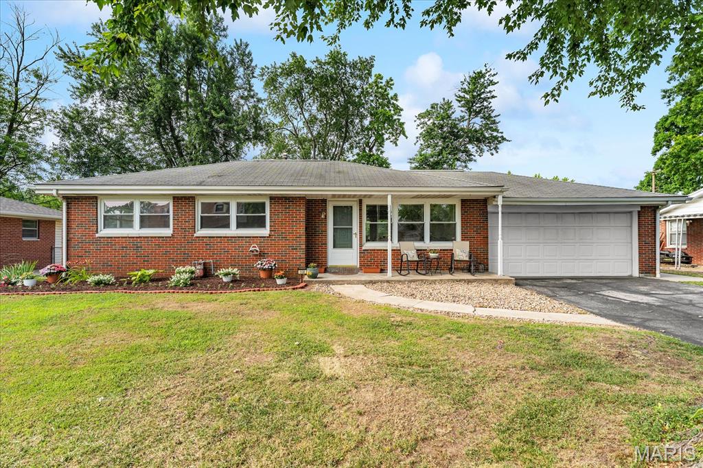 Welcome to 108 Dorchester Drive, a thoughtfully refreshed and beautifully maintained brick ranch offering the ease of one-story living plus an impressive amount of finished space below grade. With 1,006 finished square feet on the main level and another 1,006 finished square feet in the lower level, this move-in-ready home provides approximately 2,012 square feet of finished living space, three bedrooms, two full bathrooms, and a versatile floor plan designed to make every square foot count. A large front picture window fills the living room with natural light, while original hardwood flooring brings warmth and character throughout the main living areas and bedrooms. The open connection between the living room, dining area, and kitchen creates a comfortable everyday flow and makes the home feel bright, welcoming, and easy to enjoy. The spacious eat-in kitchen offers abundant cabinetry and counter space, a tiled backsplash, dishwasher, and room for a full dining table. French doors overlook the backyard and open directly to the patio, creating a natural extension of the indoor living space for grilling, dining, and relaxed outdoor gatherings. All three bedrooms are located together on the main level, each offering hardwood flooring, generous natural light, and useful closet space. Their flexible sizes make it easy to accommodate sleeping rooms, a home office, hobby space, or whatever best suits your needs. A refreshed full bathroom completes the main floor with a clean white vanity, updated fixtures, tiled flooring, and a tub/shower combination. Downstairs, the fully finished lower level nearly doubles the home’s usable living space. The expansive recreation room offers room to spread out, unwind, entertain, exercise, work from home, set up a media or game area, or combine several uses in one exceptionally flexible space. Durable tile flooring makes this level practical for active everyday living. A second large full bathroom adds valuable convenience, while a separate laundry area and additional storage help keep household essentials organized. Important mechanical improvements provide added confidence, including a water heater replaced in 2022, a sump pump installed in 2022, and an HVAC system replaced in 2023—meaning several of the home’s major systems have already received recent attention. Outside, the approximately 0.29-acre lot is level, spacious, and designed for easy upkeep. The fenced backyard provides an open lawn with plenty of room for outdoor activities, gardening, or pets, while the patio and firepit invite evenings under the trees, weekend cookouts, and casual time with friends. Mature shade trees add a pleasant backdrop without overwhelming the usable yard. The oversized attached two-car garage is another standout feature, offering more room than a typical garage for vehicles, tools, lawn equipment, storage, hobbies, or a workshop setup, and the broad driveway provides convenient additional parking. Built in 1957, this classic ranch combines enduring brick construction and original hardwood character with tasteful updates, recent mechanical improvements, and conscientious care. Located in established Dorchester Village in Belleville’s 62223 area, the property is served by Harmony-Emge School District 175 and Belleville West High School, with convenient access to everyday shopping, dining, services, and major routes throughout the Metro East and toward St. Louis. If you have been searching for a home that offers comfortable main-level living, a full finished basement, a large level yard, excellent garage space, important system updates, and the ability to move in and enjoy it from day one, 108 Dorchester Drive delivers a rare amount of flexibility and value inside and out. Schedule your private tour and come see how easily this well-cared-for home can fit the way you live.