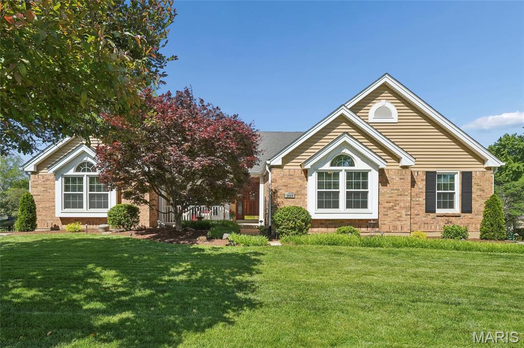 Beautiful ranch home featuring an open-concept main living area with a spacious living and dining room combination, vaulted ceilings, and a stylish wood beam accent. Large tinted windows throughout the main living space fill the home with an abundance of natural light. The oversized eat-in kitchen offers a large center island, pantry, built-in work desk, skylight, and ample counter and cabinet space. Main floor includes four generously sized bedrooms, two full bathrooms, and a convenient laundry room. The expansive primary suite features a luxurious bath with a soaking tub, separate shower, dual sinks, abundant storage and counter space, and two walk-in closets. The finished lower level includes a recreation room, additional bathroom, and a large storage area with walk-out access to the backyard. Enjoy the beautifully landscaped, park-like backyard complete with a large deck with a paver patio underneath, perfect for entertaining or relaxing. Oversized three-car garage is double deep, providing excellent space for storage, a workshop, or hobby area.