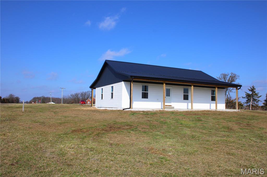 Brand new, recently completed three bed, two bath home with a two car detached garage located just west of Perry, MO at the corner of Hwy 154 and Madison Trl.  The home features an open floor plan design, stainless steel appliances, washer/dryer room, and the master bedroom has its own full bathroom with a double sink vanity.  The two car detached garage is 24x32 that has a concrete floor and there is a nice mostly covered breezeway between the house and the garage making for a great spot for entertaining guests.  The improvements sits on 5 surveyed acres. Really nice location in terms of just minutes away from several boat ramps, and also just minutes away from Perry. Seller is selling the home with a one year builder warranty.