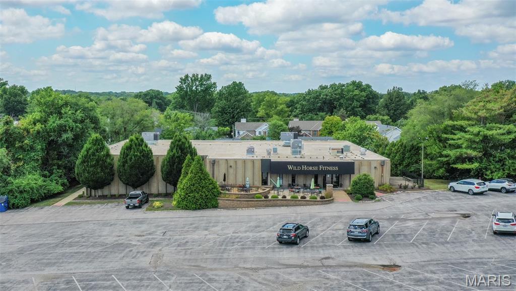 This 18,259 SF two-story facility in the heart of Ballwin, MO offers a rare turn-key opportunity for operators seeking a fully equipped fitness or wellness destination. The property is outfitted with a spacious open fitness area, two racquetball courts, modern locker rooms, and premium amenities including saunas, steam rooms, and whirlpool tubs—making it ideal for an immediate fitness or health club concept. With abundant parking, the site ensures excellent accessibility and convenience for members or customers. Beyond its current configuration, the building’s versatile floor plan makes it well-suited for a wide range of alternative uses, such as medical, recreational, or community-oriented facilities. The thoughtful design provides flexible space for group training studios, rehabilitation or wellness practices, and other specialized services, while maintaining the infrastructure of a premier athletic facility. Strategically positioned near the intersection of Kehrs Mill Road and Clayton Road, the property benefits from strong visibility and accessibility within a highly desirable trade area. With an average household income of $176,000 within just one mile, the surrounding demographics provide a robust customer base for high-end fitness, health, or service-oriented businesses. This property is a rare opportunity to secure a prime, well-appointed facility in one of St. Louis County’s most affluent and dynamic communities.