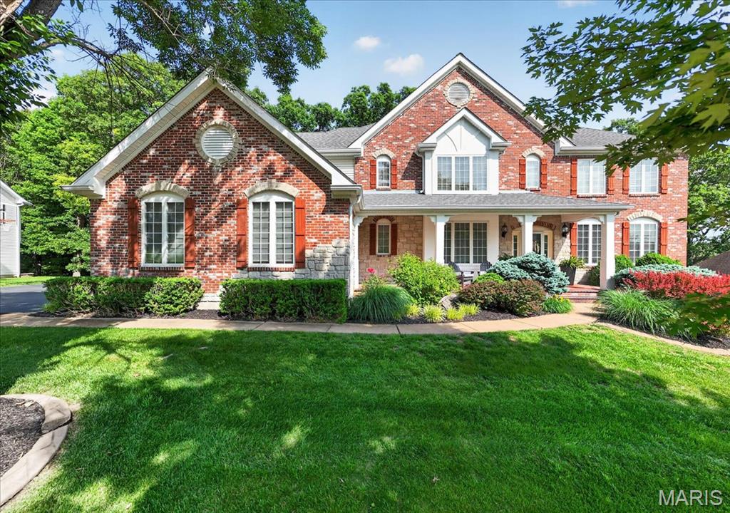 Nestled in the heart of Wildwood, this magnificent 5-bedroom home in the highly sought after Garden Valley subdivision offers the best of both sophisticated indoor living and a breathtaking outdoor space. Rich curb appeal greets you with a striking brick and stone elevation, framed by professional landscaping & spacious side-entry 3-car garage. This masterfully designed exterior promises warmth and character that carries through every detail inside. Step inside onto gleaming hardwood floors at 2-story foyer that carry all the way upstairs! Spacious dining room w/grand archways & picture frame molding is the perfect spot for holidays or special occasions. Cozy family room anchored w/wood-burning fireplace & wall of windows, too! Move into the inviting gourmet kitchen complete w/spacious center accent island, JennAir gas cooktop w/grill, double ovens, breakfast room, granite counters & separate bar space or serving counter! WOW! Don't miss the sun-drenched hearth room w/vaulted ceiling centered around a stunning stone fireplace - the ultimate retreat for morning coffee! On crisp days, consider stepping outside to the screened-in deck to start your day instead. Designed for effortless daily living, the main floor thoughtfully includes a dedicated mud room w/laundry just off the heart of the home. Upstairs offers additional hangout space in the vaulted loft, conveniently placed outside the 4 incredibly spacious bedrooms, each with their own private en suite & walk-in closet! The expansive primary serves as a quiet haven, elegantly appointed with tray ceilings & plantation shutters, plus a bedroom-sized closet & newly renovated bathroom w/sleek white tile, soaking tub, walk-in shower, dual comfort-height vanity & storage nook. Downstairs, the finished walk-out lower level dramatically expands your living and entertaining options. This bright, versatile space features a flexible room perfect for a private home gym or 5th bedroom, recreation room, office or craft room, bar counter (wine fridge to stay!), storage space and a full bathroom. Enjoy your scenic backyard with expansive deck, spacious patio, and built-in fire pit w/seat wall. The outdoor experience is anchored by a premium, included SWIM SPA - your personal year-round escape for fitness or relaxation! Imagine hosting summer gatherings on the uncovered terrace, all while enjoying a remarkably peaceful view of mature trees. With 2 newer water heaters & dual HVAC systems plus an electric fence, this home delivers complete peace of mind alongside its undeniable beauty. Built-in speakers, central vac & irrigation, too! With near immediate access to the Wildwood trail system and located in the award winning Rockwood School District, this location can't be beat! Don't miss the chance to be the newest neighbor at Garden Valley! Welcome home!