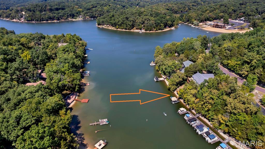 FULLY FURNISHED WATERFRONT HOME ON DEEP WATER & MAIN LAKE! Welcome to 1378 S Lake Sherwood Drive in beautiful Lake Sherwood, Missouri! This move-in-ready waterfront retreat comes fully furnished, with all furniture, appliances, bedding, kayaks, and household contents included with the sale at zero value—just bring your personal belongings and start enjoying lake life! Ideally situated very close to the water on the main lake with deep-water frontage, this home offers breathtaking water access and an incredible outdoor lifestyle. Multi-level decking leads from the home down to your private boat dock, while a new composite viewing deck near the water provides the perfect spot to relax, enjoy the lake, or watch the sunset. Inside, the open floor plan is filled with natural light. Wall-to-wall windows across the rear of the home bring the beauty of the lake indoors, while skylights add even more brightness throughout the living space. The kitchen features custom cabinetry, granite countertops, and a breakfast area with walkout access to the deck, making entertaining and enjoying the waterfront views effortless. The main level also offers convenient laundry and 3 bedrooms and 2 bathrooms. The lower level provides even more space with an additional sleeping area and spacious recreation/family room, perfect for guests, family gatherings, or relaxing after a day on the lake. A screened-in porch offers a comfortable place to enjoy the outdoors, while the lower-level deck is partially covered and wraps around the home with convenient access to the garage. Additional outdoor features include an extra parking pad at street level, providing plenty of parking for family and guests. Notable improvements include a new AC and furnace in 2021, LVT flooring added in the basement, new carpet in the upstairs bedrooms, new concrete dock, new composite viewing deck near the water, replaced skylights, a new landscaping stone wall for the upper-level off-street parking, and an upgraded drainage system at the front of the home. Whether you're looking for a full-time residence, weekend getaway, or a place to gather with family and friends, this property offers the best of Lake Sherwood waterfront living—deep water, main-lake frontage, private dock, abundant outdoor space, and a home that's ready to enjoy from day one!