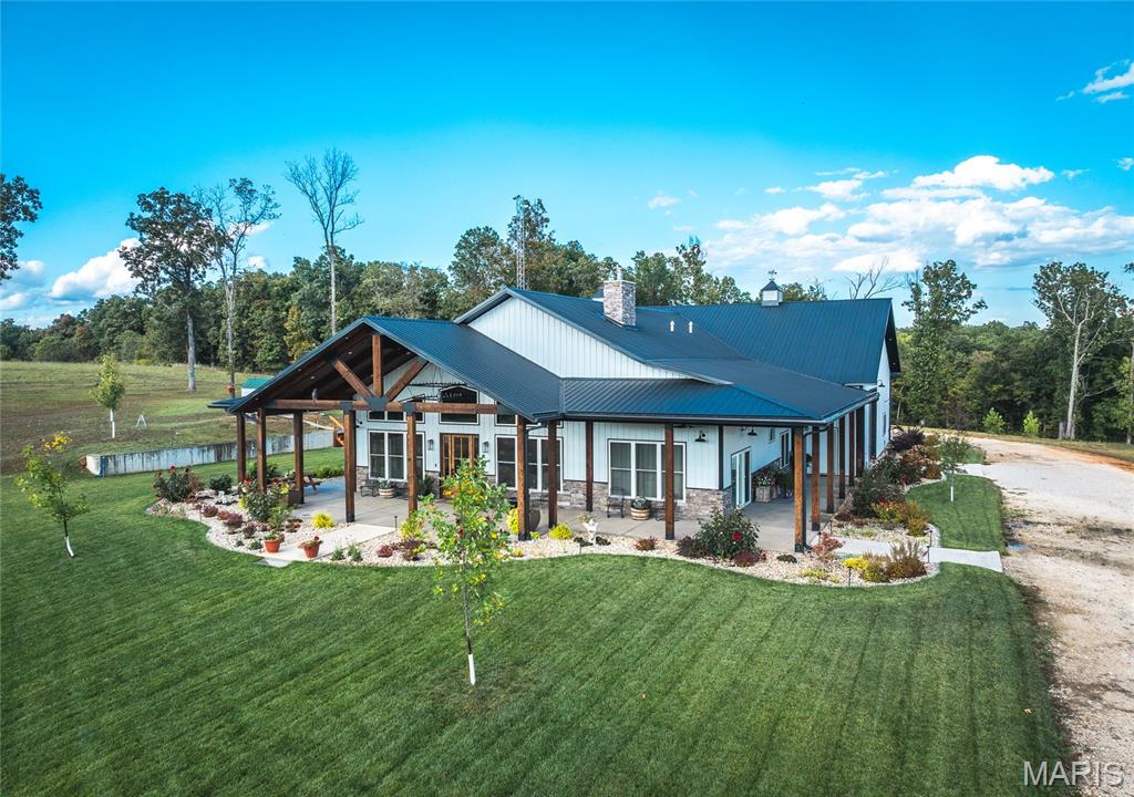 Located on 209 m/l pristine acres of rolling Missouri countryside, this one-of-a-kind private estate offers the perfect blend of luxurious modern living, timeless craftsmanship, and unparalleled outdoor recreation. At its heart stands a stunning barndominium-style home totaling 5,500 square feet, featuring a spacious 2,000-square-foot, 3-bedroom, 2-bath residence seamlessly connected to a massive 3,500-square-foot attached shop. This is more than a home — it’s a meticulously crafted, nearly maintenance-free sanctuary designed for those who appreciate beauty, privacy, and functionality.

Step inside the residence and be captivated by high-end finishes and thoughtful details throughout. The kitchen showcases elegant quartzite stone countertops, while granite stone surfaces grace the remaining areas. Polished concrete floors flow seamlessly underfoot, offering durability and modern elegance. A charming 100-year-old restored stained glass door on the pantry adds a touch of historic character and artisanal beauty. Stay cozy year-round with a wood-burning stove. No corners were cut in the building of this home — the walls are fully spray foamed for maximum efficiency, and the property is equipped with a complete security camera system.

The attached 3,500-square-foot shop is a standout feature, complete with its own independent HVAC system (separate from the house), making it ideal for hobbies, vehicle storage, workshops, or entertaining. A second driveway provides convenient access to two additional outbuildings: a 30x30 and a spacious 50x70, offering excellent flexibility for equipment, storage, or projects.

Outside, the grounds are nothing short of spectacular. Professional landscaping, designed by an architect, surrounds the home with lush, fully irrigated lawns and timed outdoor landscape lighting that creates beautiful evening ambiance. Roughly 40 acres of open pasture and multiple ponds enhance the natural beauty and offer peaceful retreats. The remaining acreage is a hunter’s paradise, renowned for excellent deer and turkey hunting with several great pinch points and established food plot locations in a highly private setting.

Just a short drive from the Lake of the Ozarks, this estate provides effortless access to world-class fishing, boating, and endless outdoor adventures while maintaining a secluded, peaceful atmosphere.

A truly unique and high-quality country estate built with pride and attention to every detail.


Interior pictures coming soon! Pre-approval or proof of funds required prior to showing.